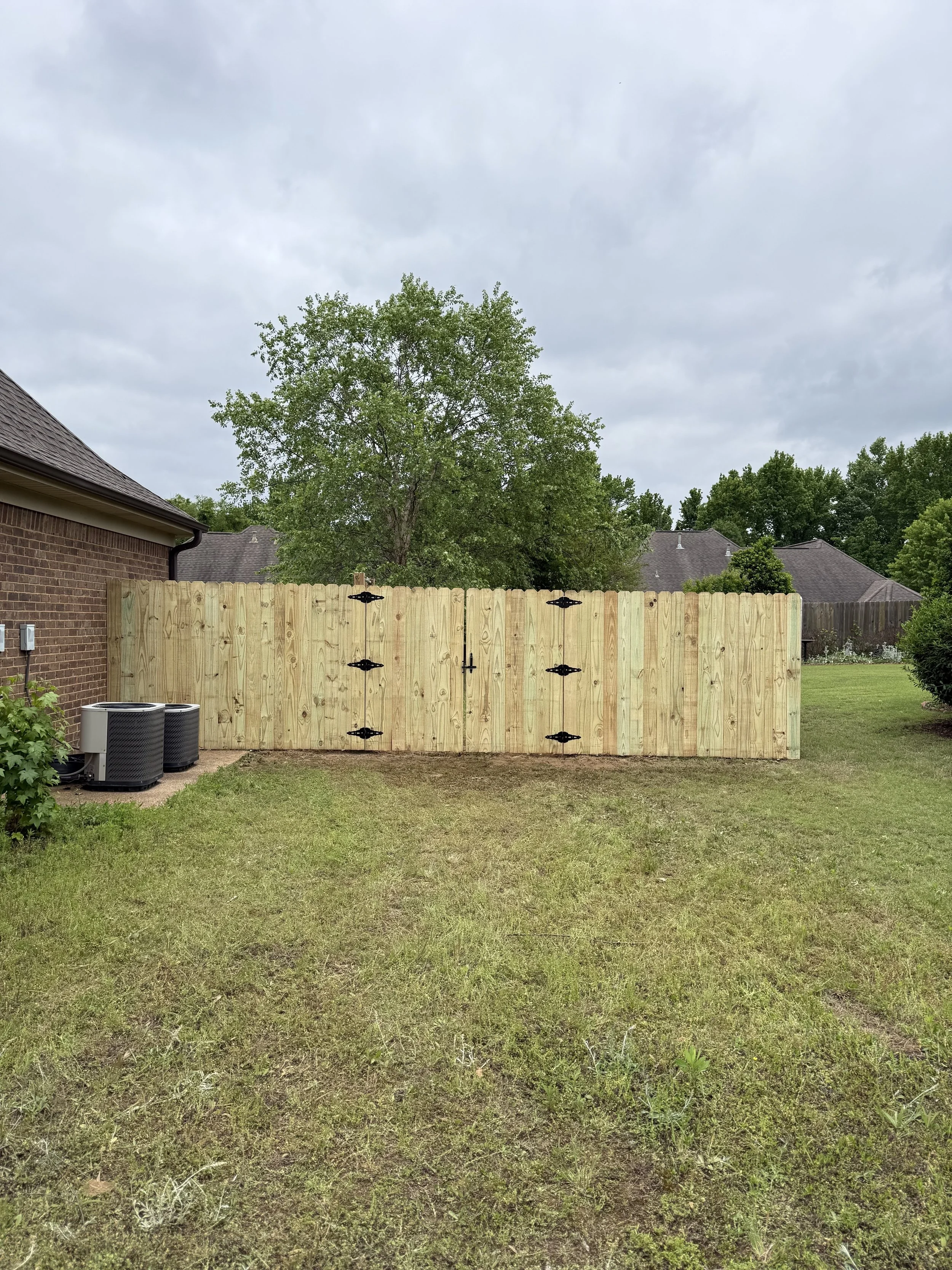 Pine privacy fence with custom double cedar frame gates built in Southaven, MS by DeSoto Fence Co.