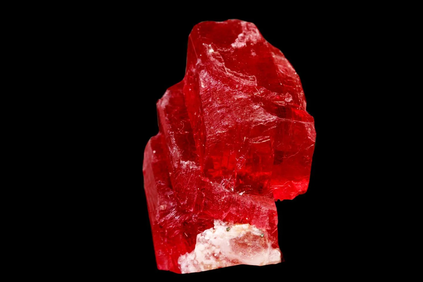 Say hello to Rhodochrosite - this material can grow in two different forms.

The first photo is gem-grade rhodochrosite, exceptionally rare due to its softness, fragility, and scarcity of transparent crystals large enough for faceting.  Fine-quality 