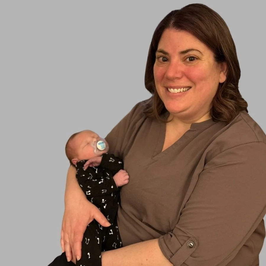 Certified birth doula Shauna Davis holding newborn baby whose birth she supported located in Racine, WI.