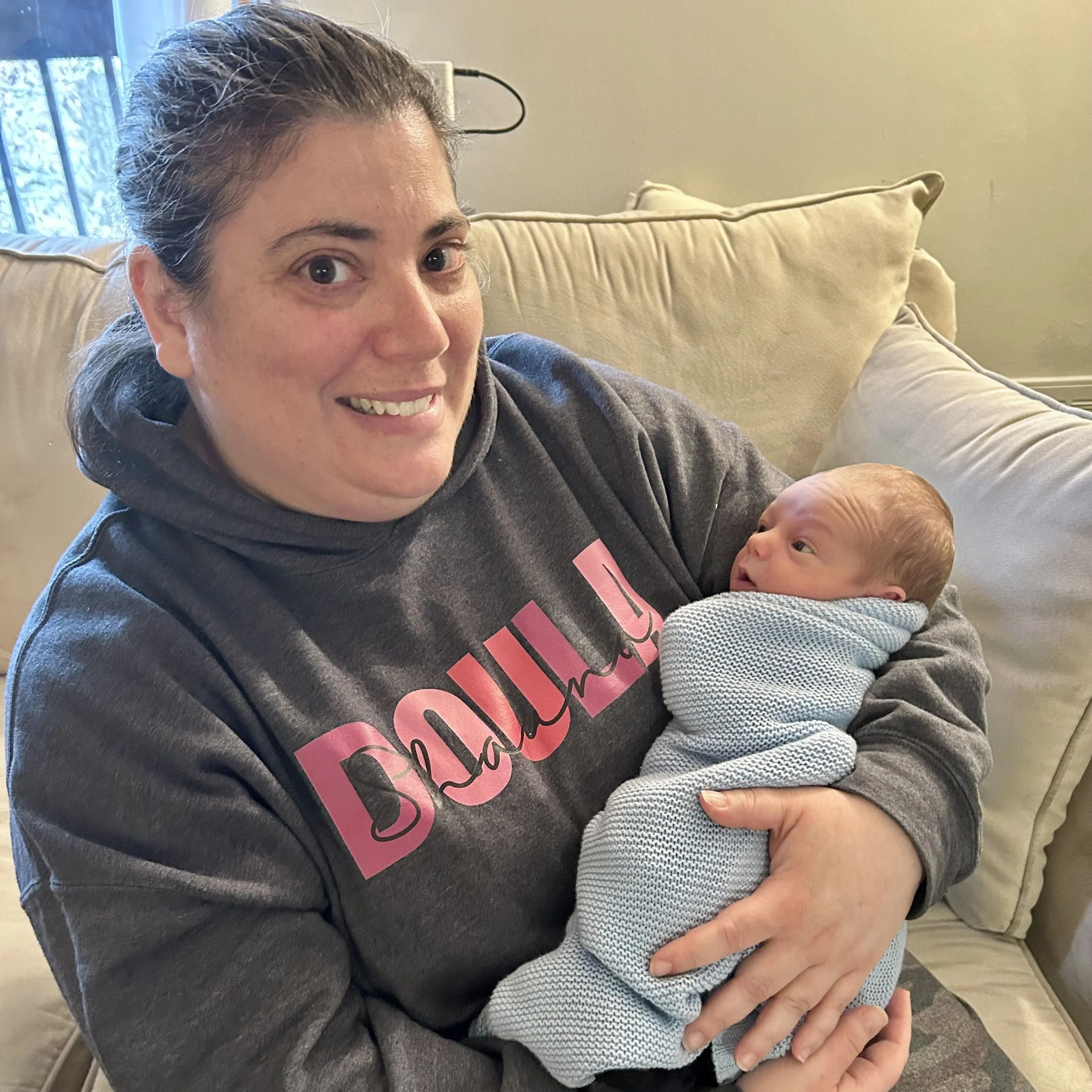 Wisconsin certified birth doula Shauna Davis supporting newborn born in the hospital at a postpartum visit.