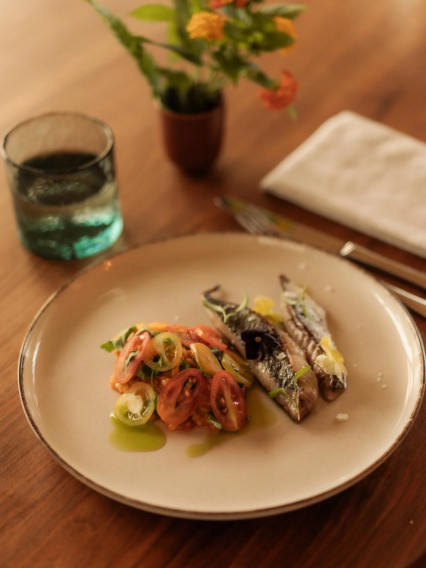 A seasonal dish with garden tomatoes and coriander at the center, completed with Pedrogr&atilde;o mackerel and rich tones from the season.

#QuintaFilippa #SeasonalKitchen #PortugalFlavours #CountryCooking #FarmAndSea #HilarioInTheKitchen