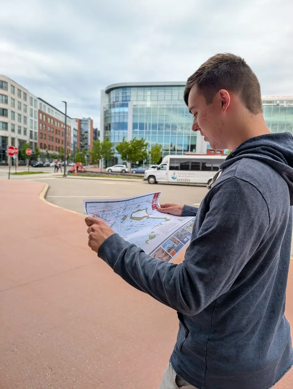 Tanner Exploring Portland Maine with a map