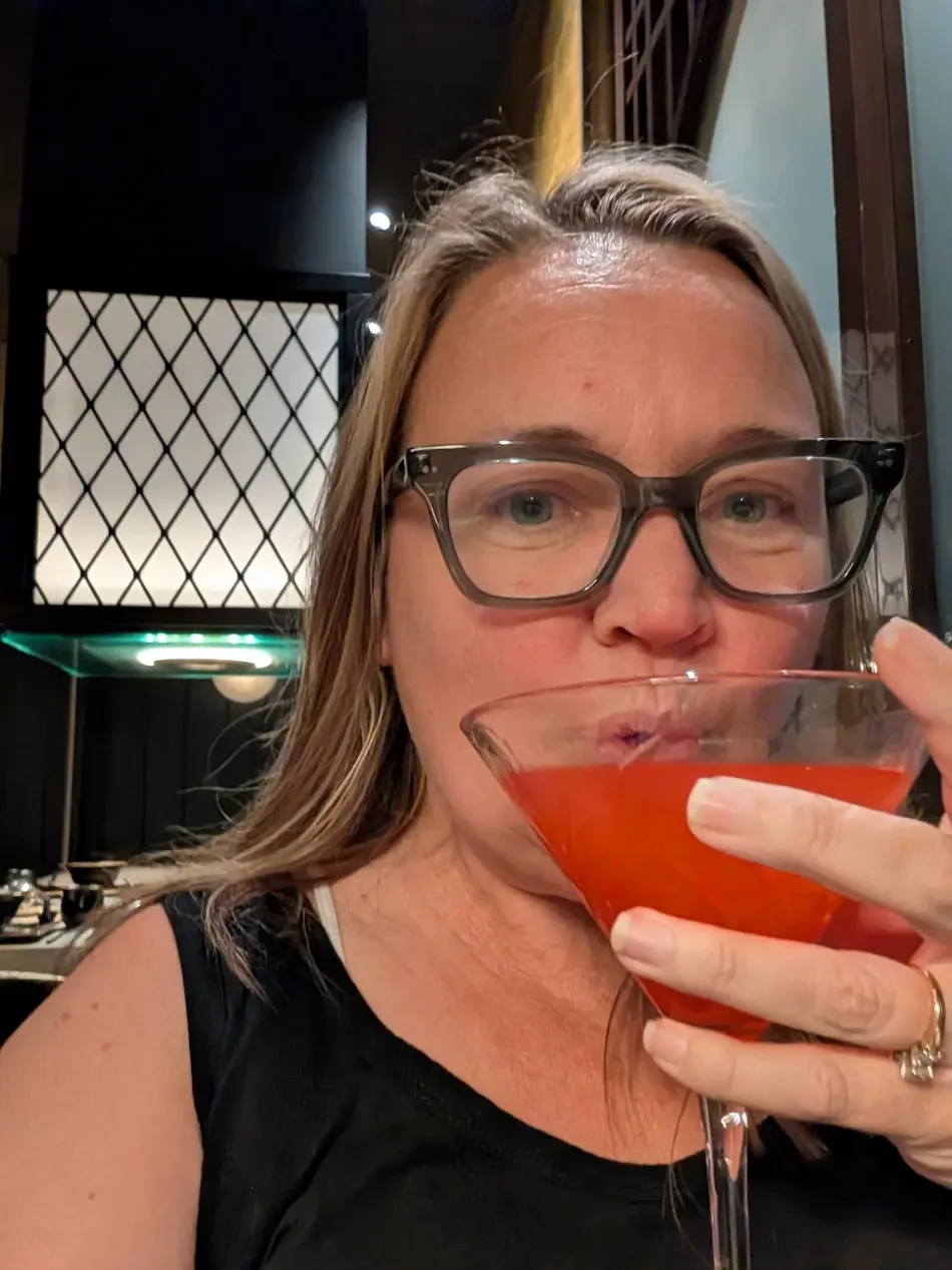 Julie drinking a fancy cocktail on the Sun Princess