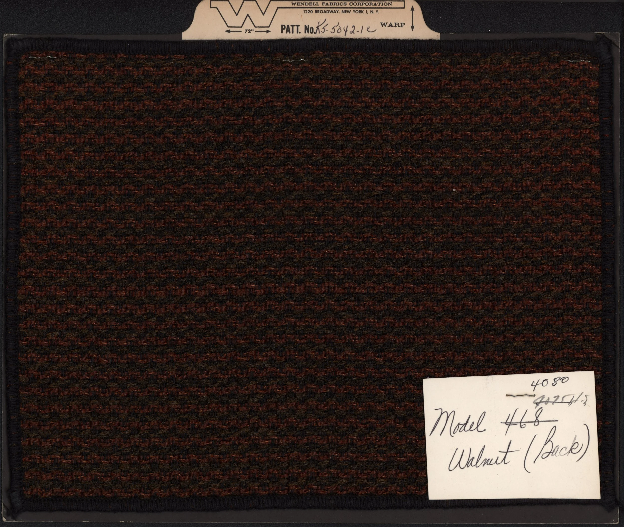 Close-up of a fabric sample card with a pattern of brownish-red and black stripes, labeled with manufacturer information and a handwritten note indicating model number 468.