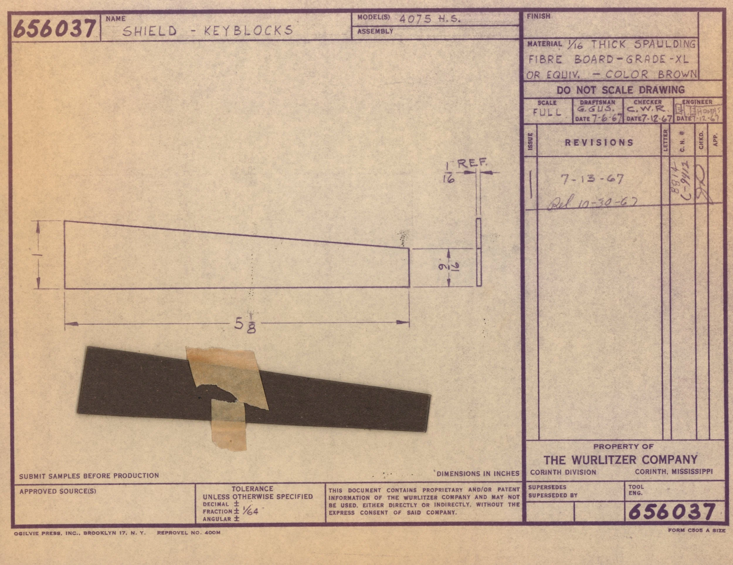 A technical drawing with measurements for a shield keyblock, made of 1/16 inch thick spawnboard material, colored brown. There is a black piece of material taped to the drawing.