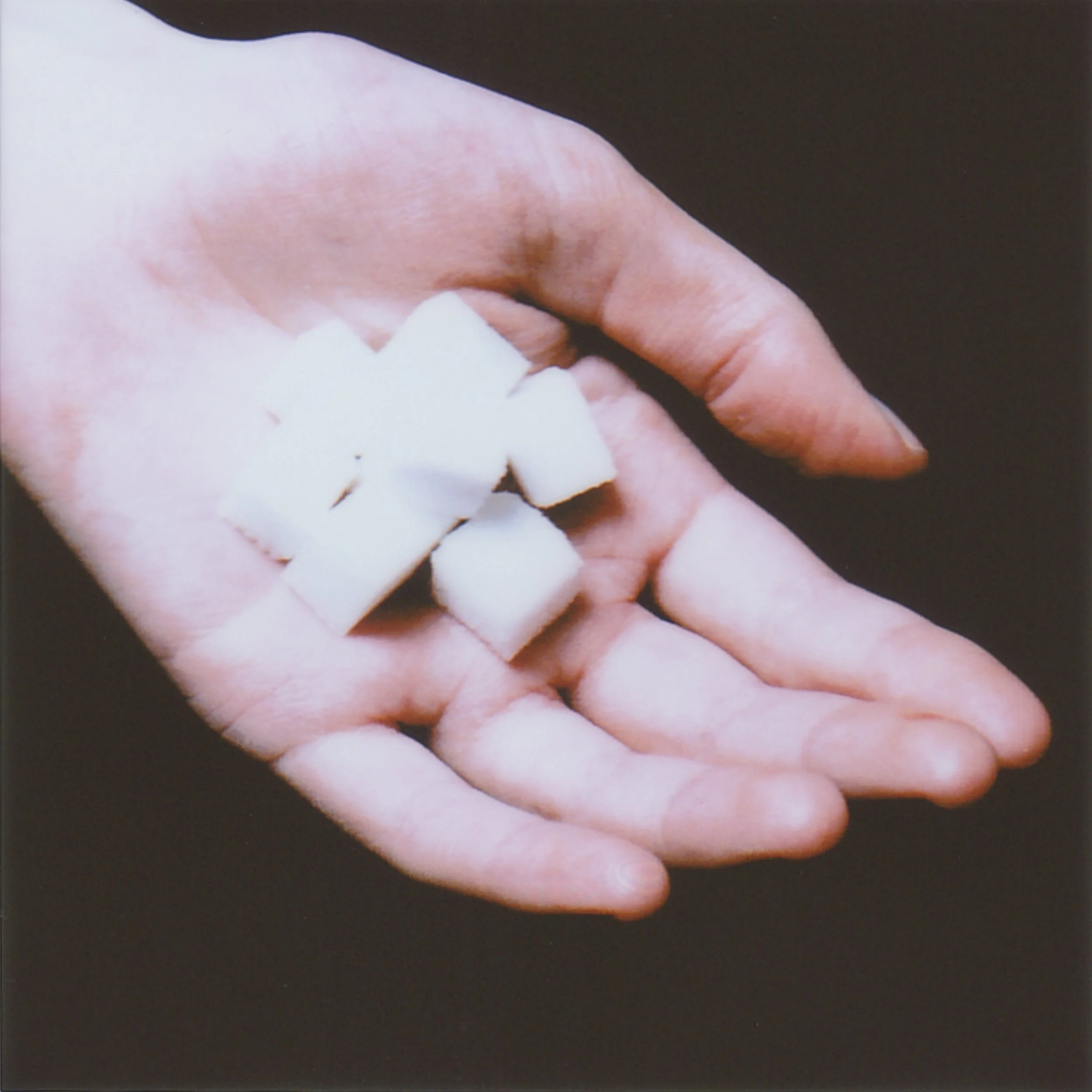 On the table stands a little bowl of sugar cubes. I watch grandpa drink tea and eat sugar. I want to imitate him because I admire and respect him so much. He is tall, gray-haired; everyone says he is very intelligent and strict—but with me, he is kin