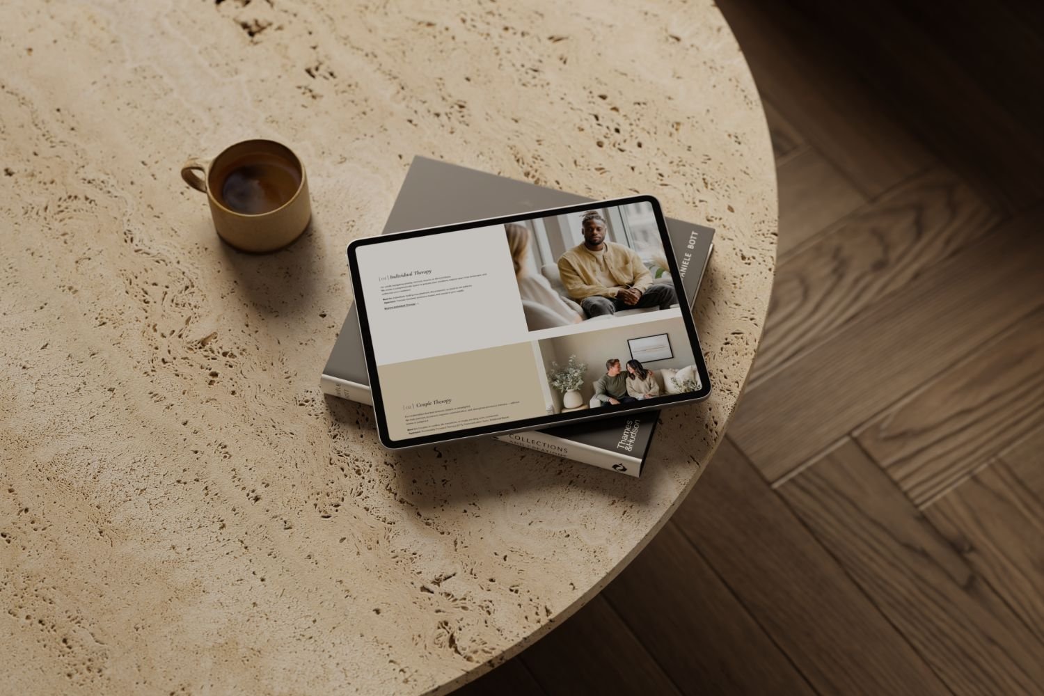 A beige coffee mug filled with coffee, a tablet displaying Dharma Services section designed for therapists and psychologists by Estudio Bohora.