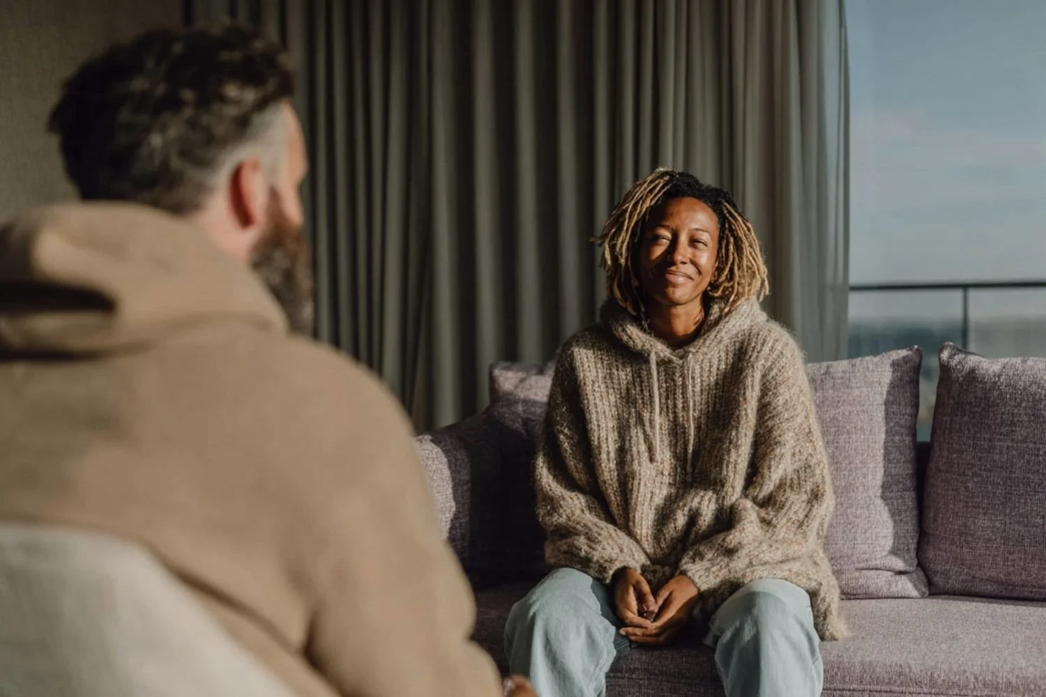 Client and therapist in a supportive conversation reflecting clarity and comfort in a therapy space