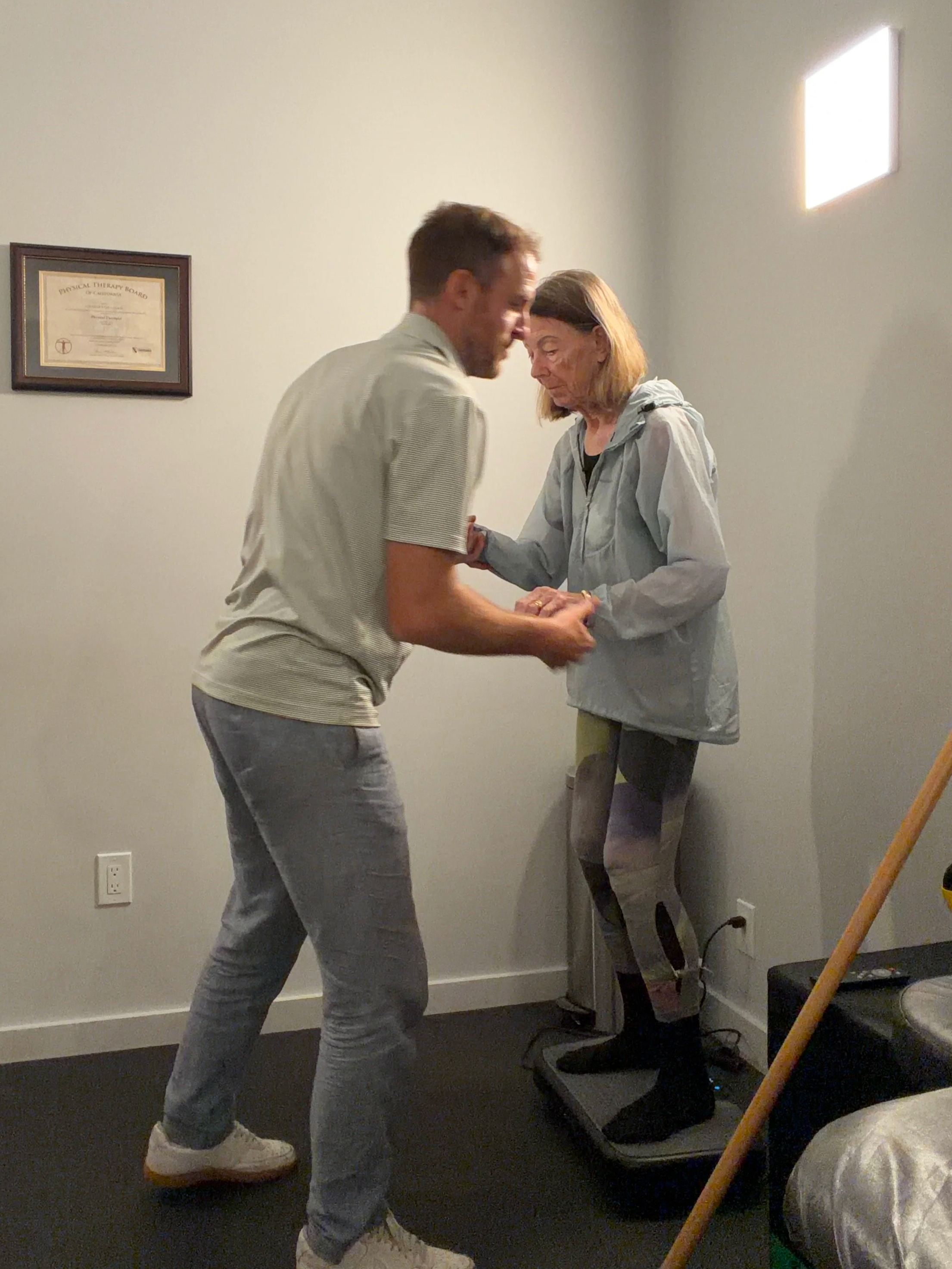 Dr. Charles helping patient with a balance activity