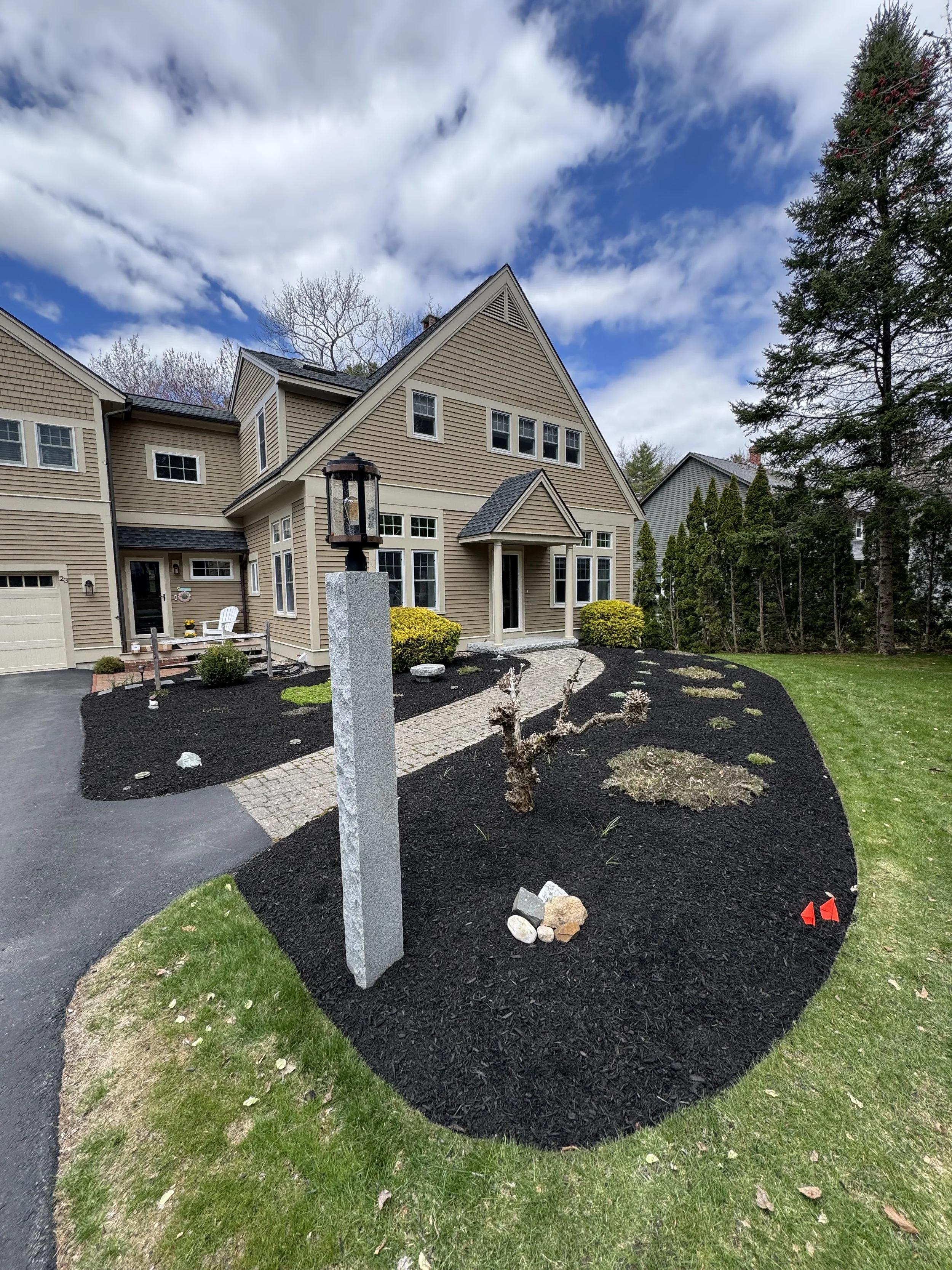 Fresh mulch installation in garden beds in front yard