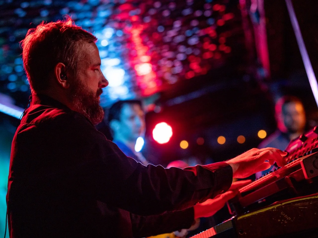 Playing keys live onstage.