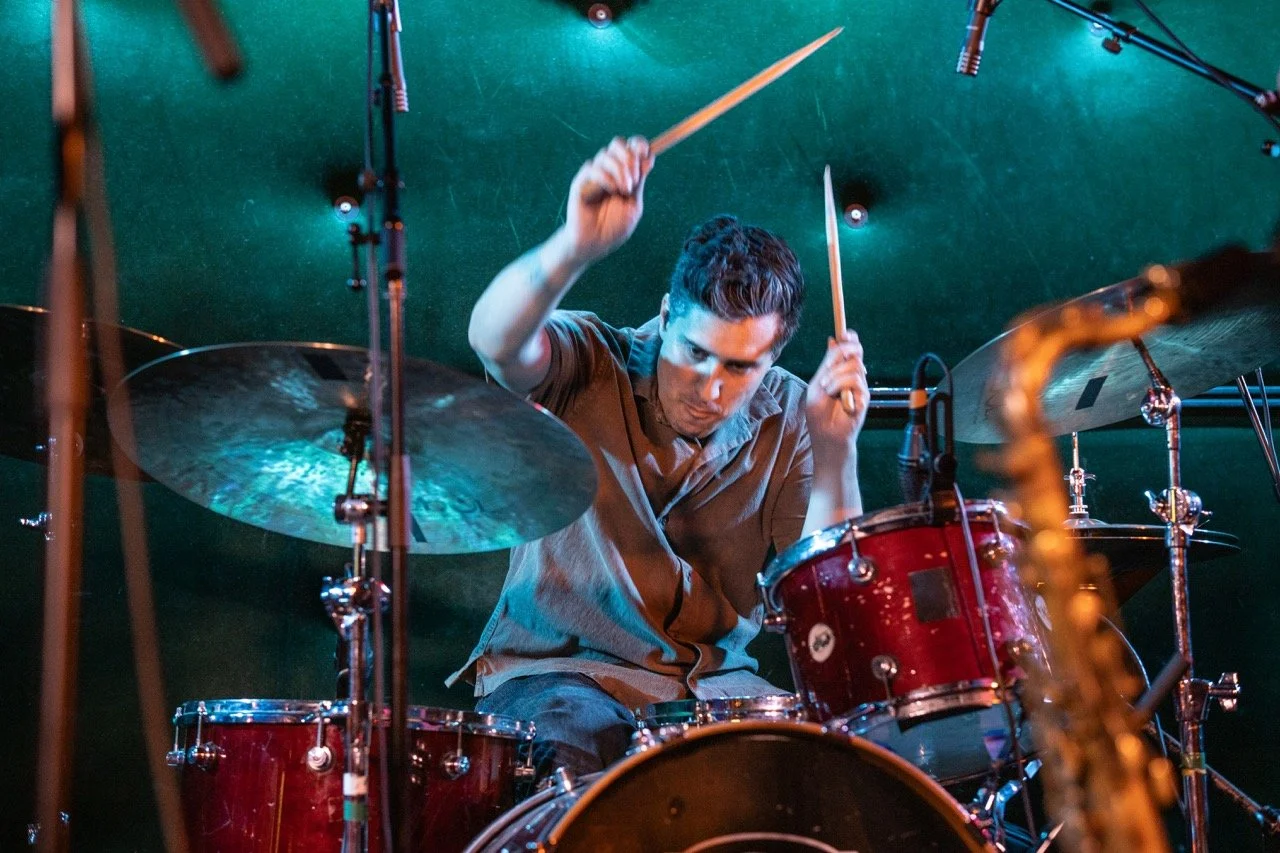 Drummer about to hit cymbals.