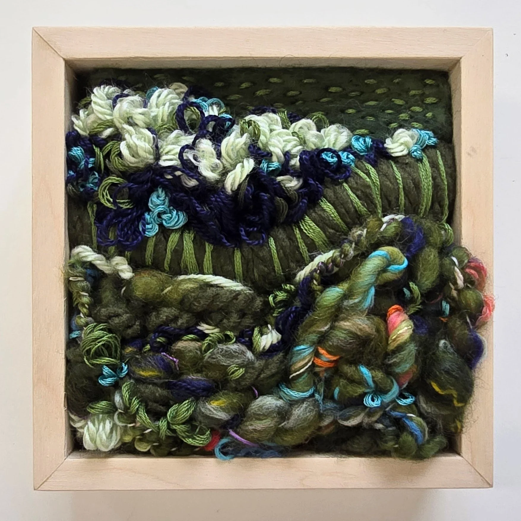 Greenbelt | Needle felted wool, handspun art yarn, mixed yarns, & stitching in a solid birch frame with natural finish | 5" x 5" x 2" | $125 (CDN) ***Available at Tiny Ass Art Gallery, St. Jacobs, Ontario in May 2026