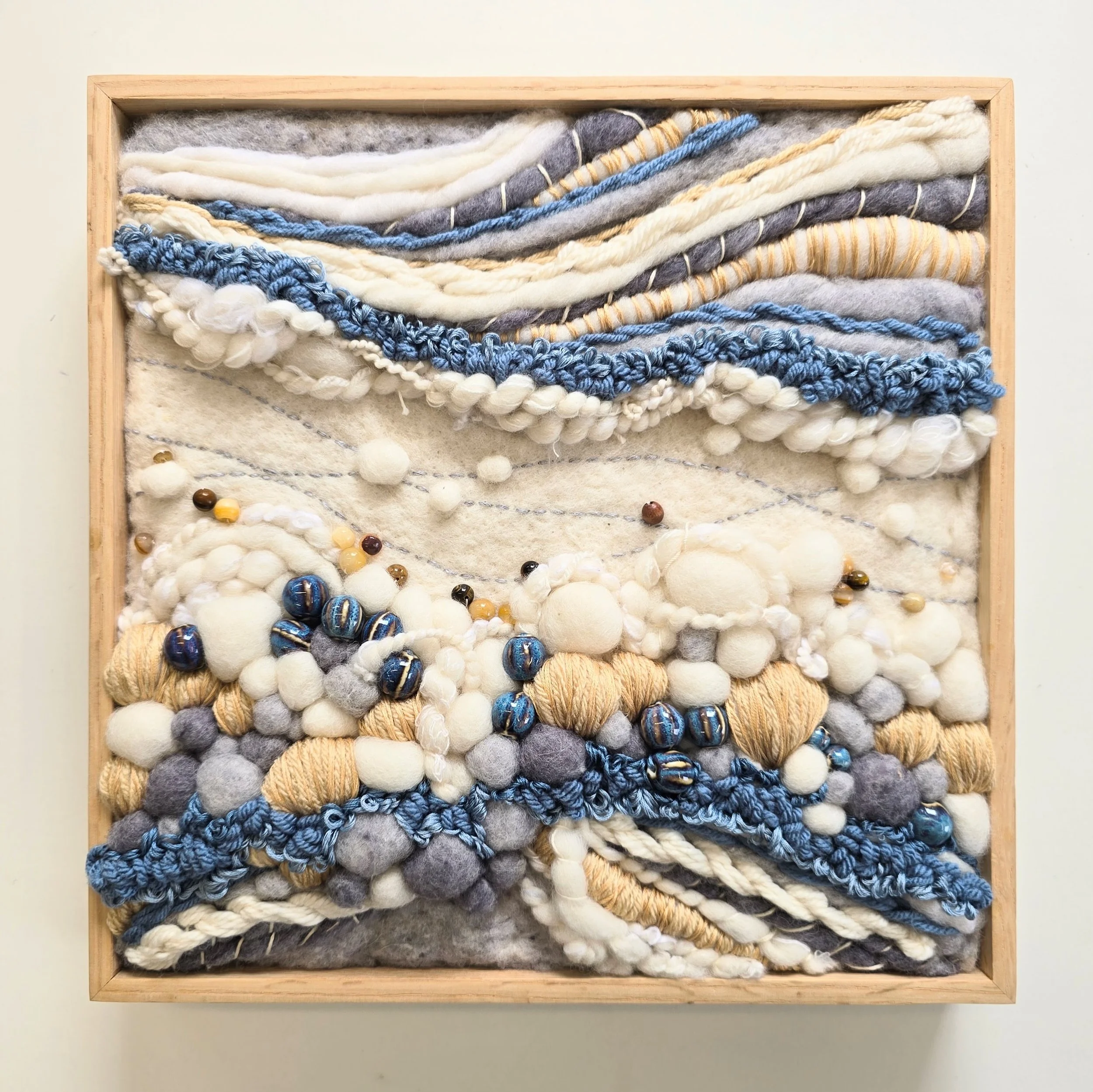 Icefields | Needle felted wool, handspun art  yarn, stitched yarns, embroidery, and ceramic & stone beading, solid oak frame with natural finish | 13" x 13" x 2" | $450 (CDN) 