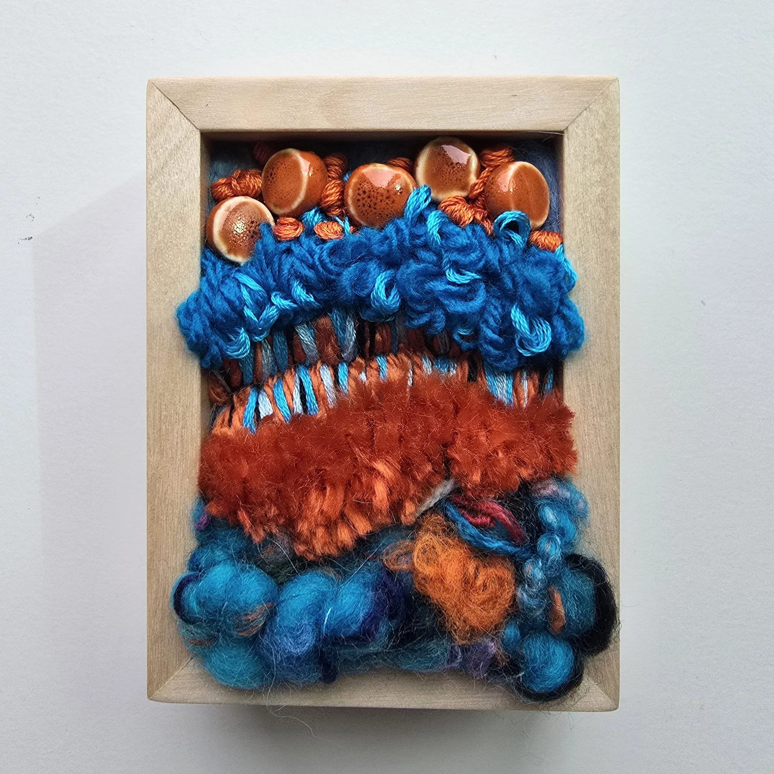 Mini 13 | Needle felted wool, mixed yarns, handspun art yarn, stitching, & ceramic beading in solid birch frame with natural finish | 3" x 4" x 1.5" | SOLD