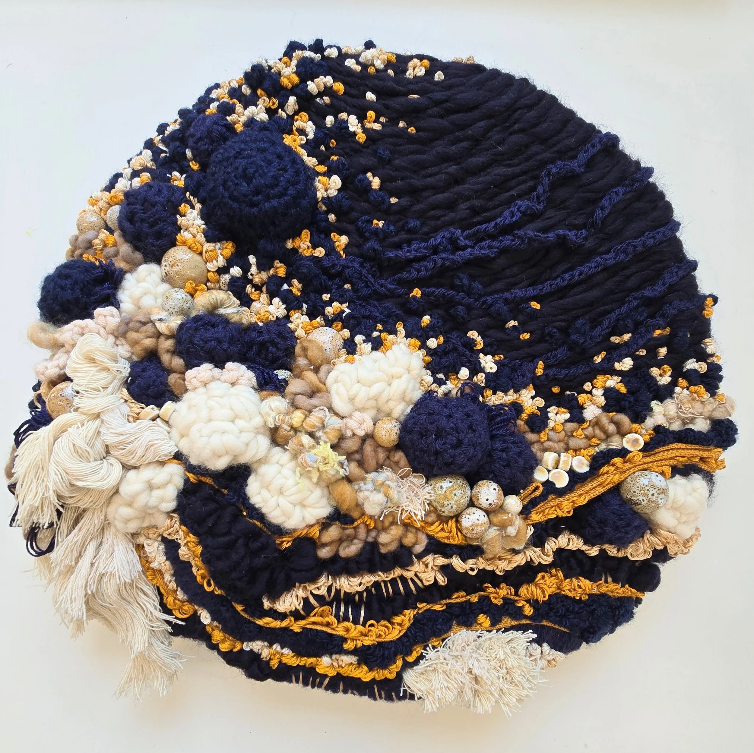 Turning Tides | Hand spun art yarns, mixed yarns, mixed textiles, cotton rope, stitch, & ceramic beading, mounted on board  & wired for hanging | 17" diameter x 2" | $750 (CDN)