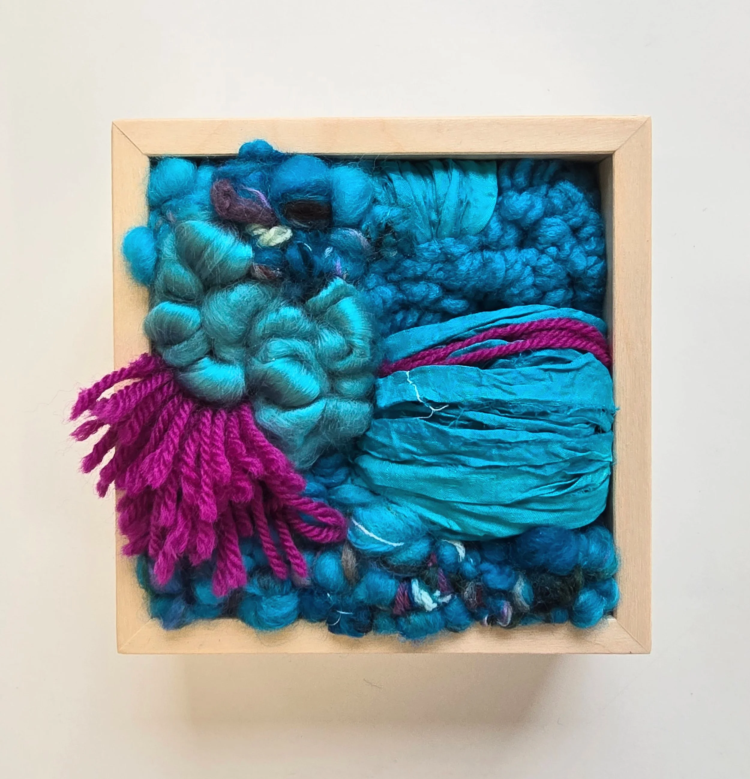 Wild Thing | Hooked wool and mixed yarns, handspun art yarn, wool roving, and recycled sari silk, in a solid birch frame with natural finish | 5” x 5” x 2” | $125
