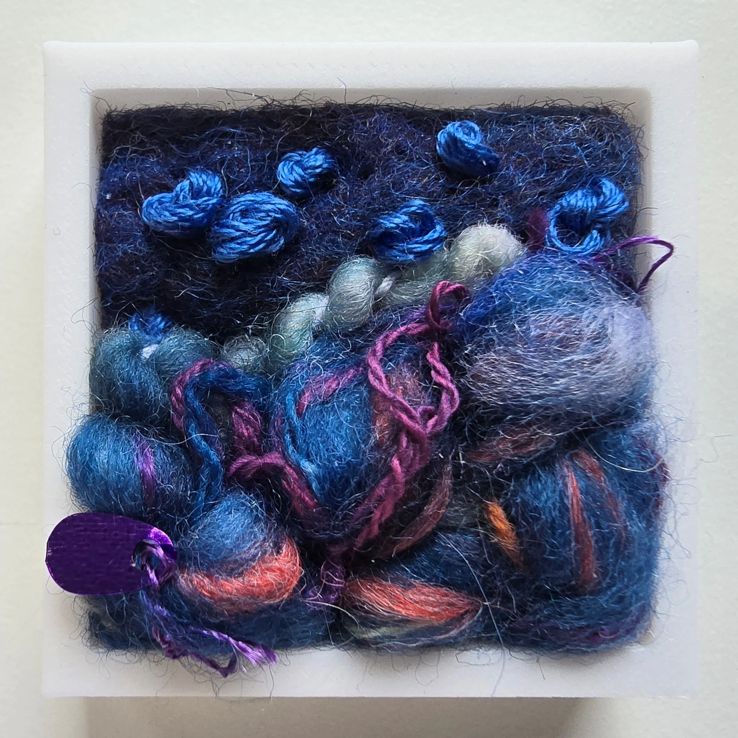Mini 7 | Needle felted wool, handspun art yarn, & stitching in a white composite frame | 1.75" x 1.75" x 0.5" | SOLD