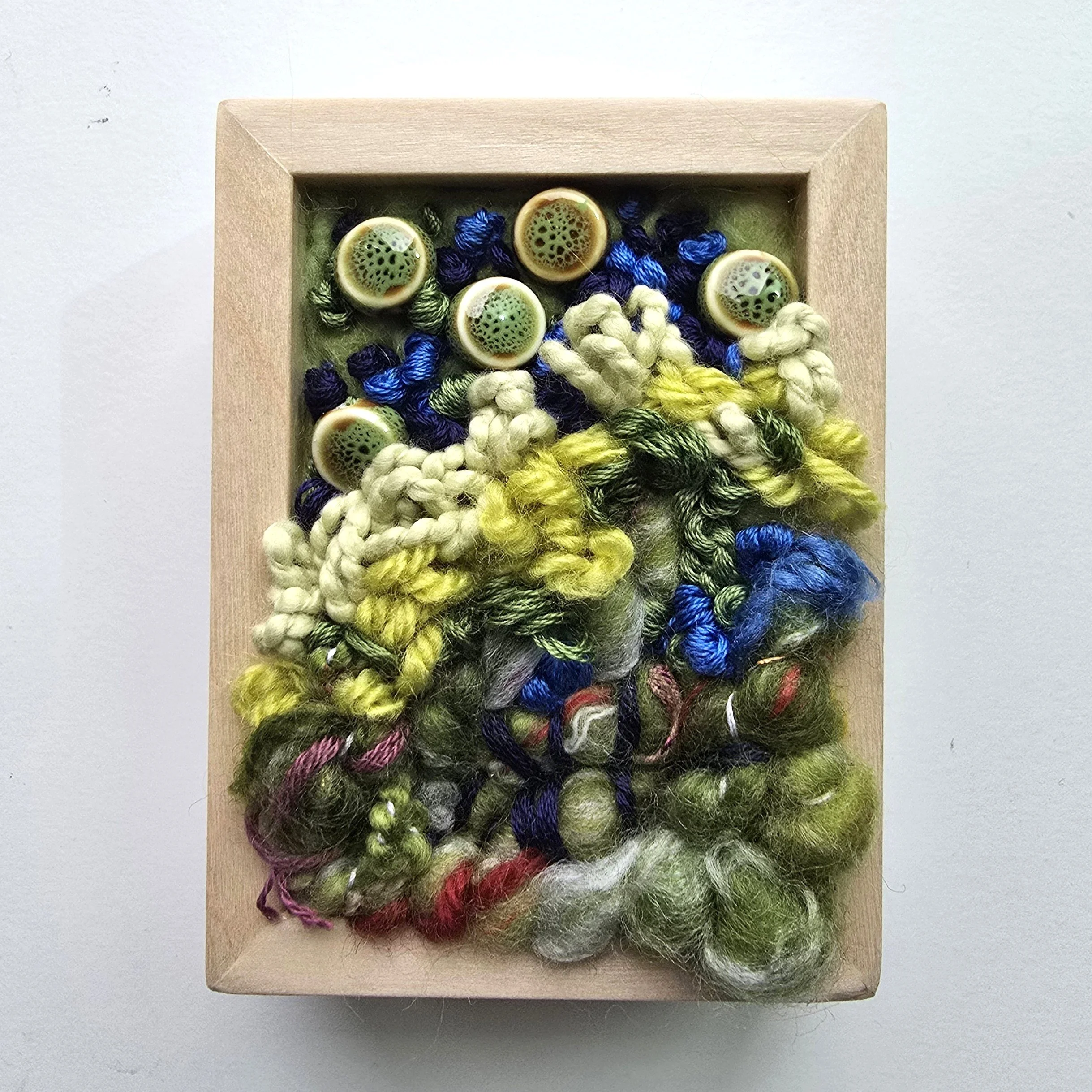 Mini 10 | Needle felted wool, mixed yarns, handspun art yarn, stitching, & ceramic beading in solid birch frame with natural finish | 3" x 4" x 1.5" | $50 (CDN)