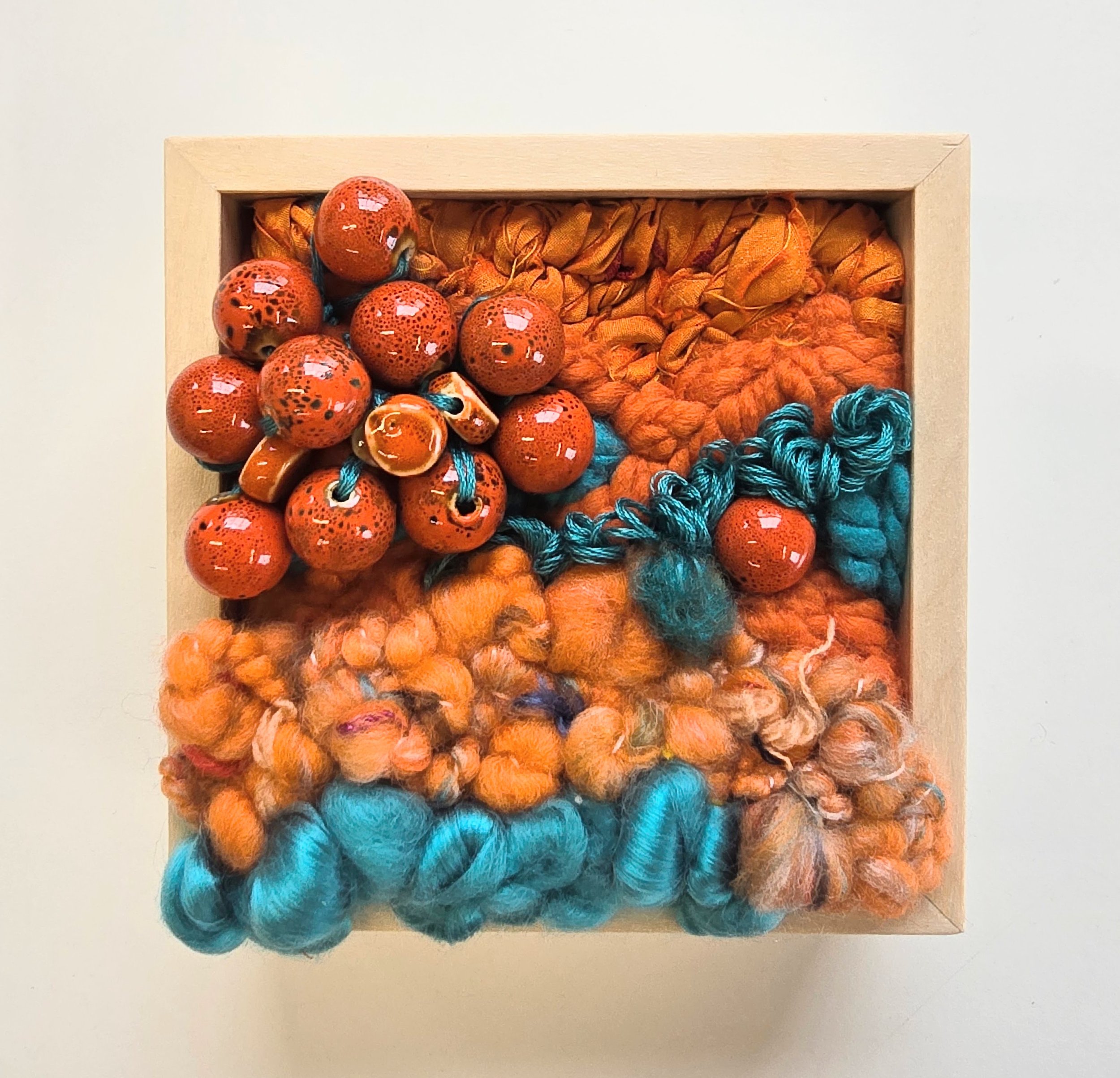 The Mosh Pit | Hooked wool and mixed yarns, handspun art yarn, wool roving, recycled sari silk, and ceramic beading in a solid birch frame with natural finish | 5” x 5” x 2” | $125

