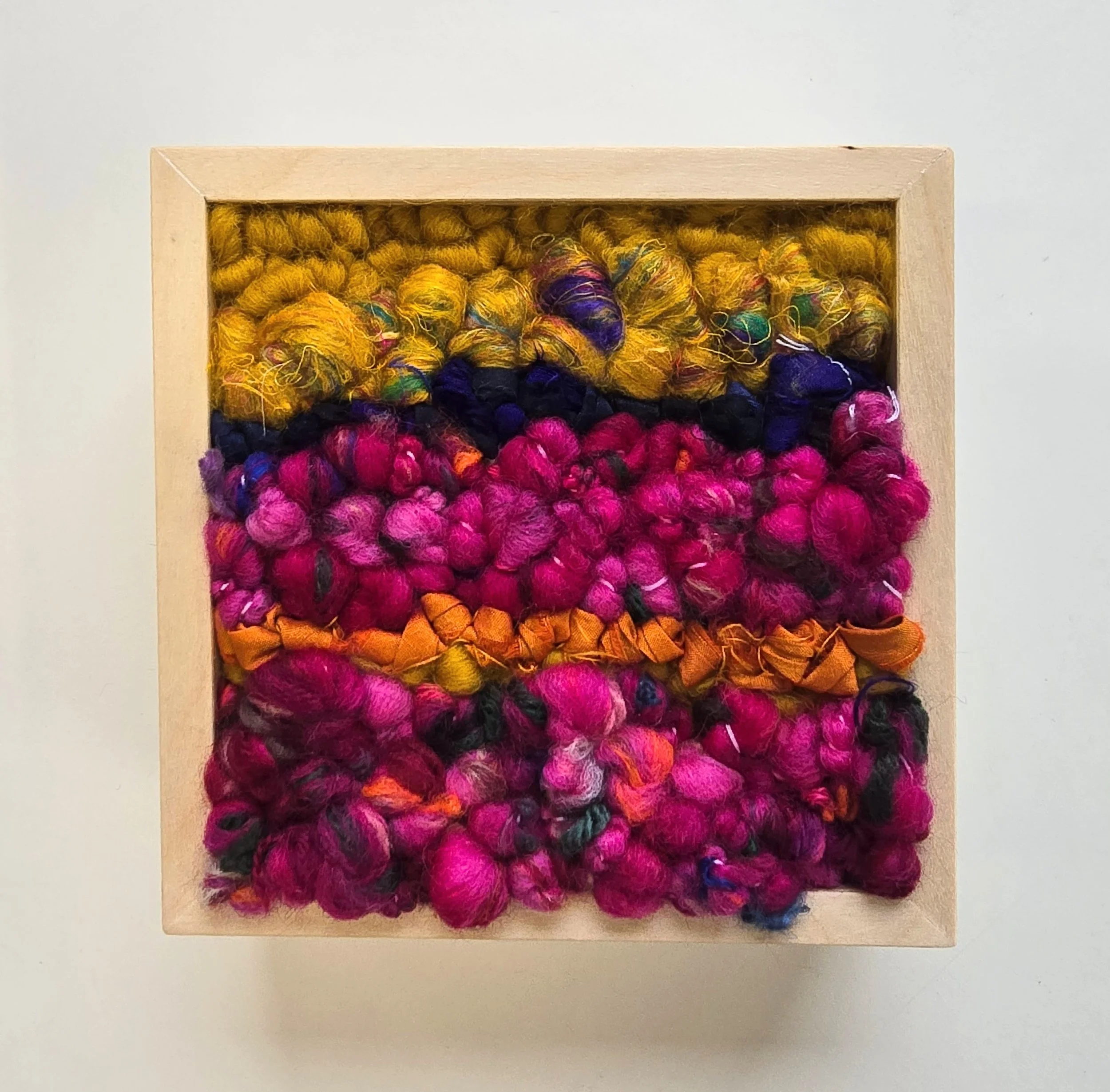 Dancing Queen | Hooked wool, handspun art yarn, silk roving, and recycled sari silk, in a solid birch frame with natural finish | 5” x 5” x 2” | $125