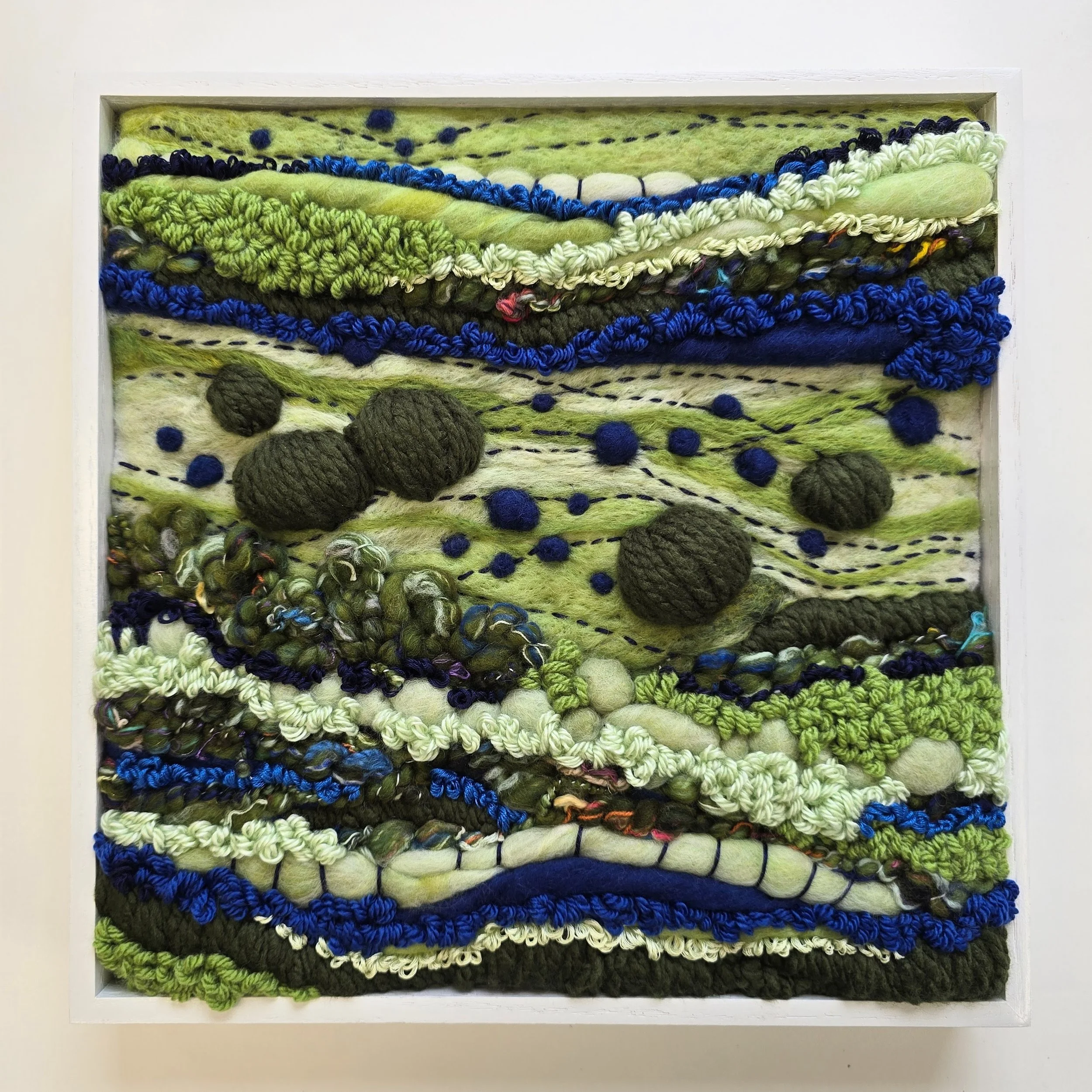 Field & Stream | Needle felted wool, handspun art yarn, & stitching in a solid wood frame with white painted finish | 13" x 13" x 2" | $450 (CDN) ***Available at Tiny Ass Art Gallery, St. Jacobs, Ontario in May 2026