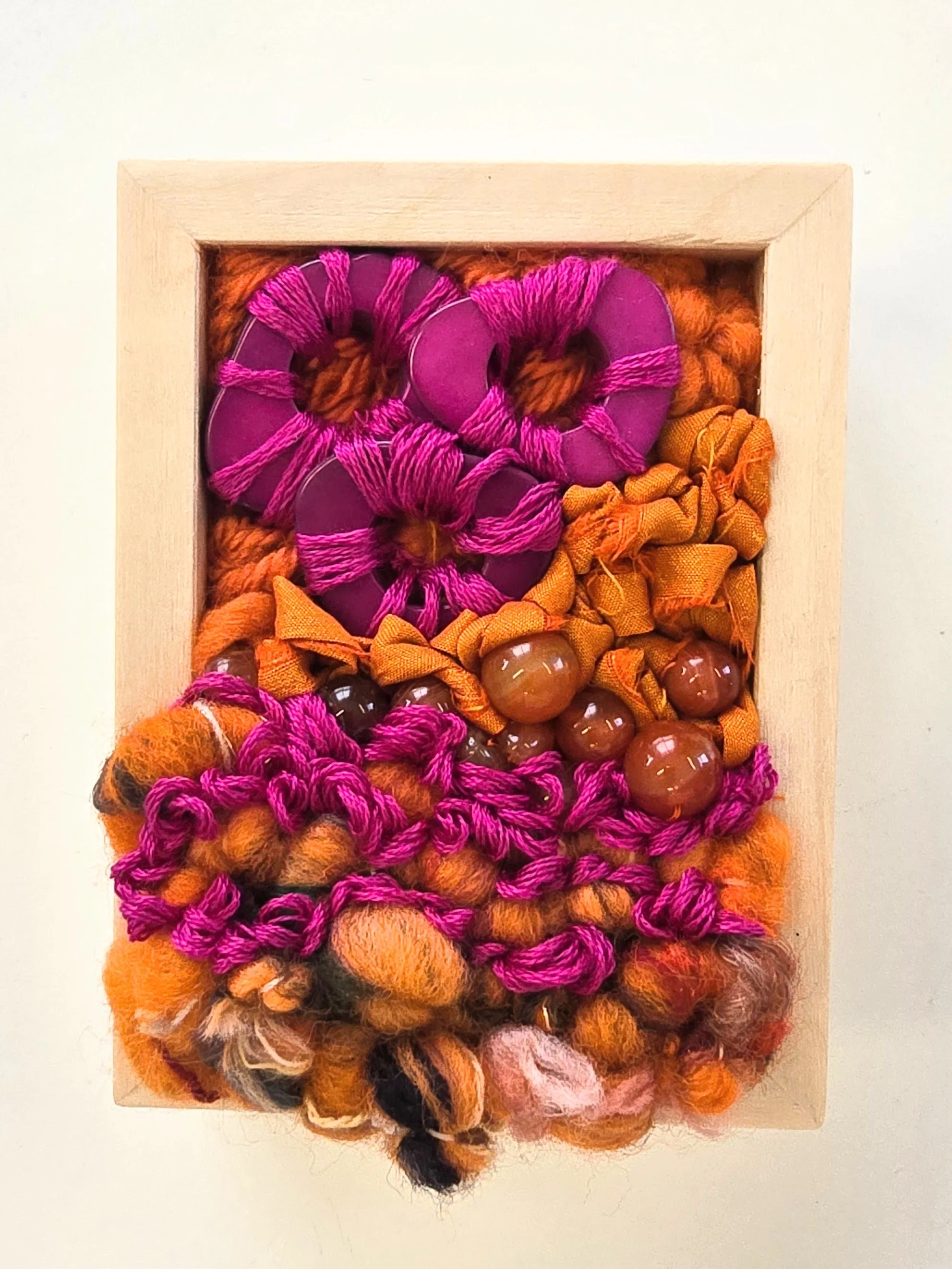 Mini 16 | Stitched mixed yarns, handspun art yarn, cotton thread, recycled sari silk, and stone & composite beading in a solid birch frame with natural finish | 3" x 4" x 1.5" | $50