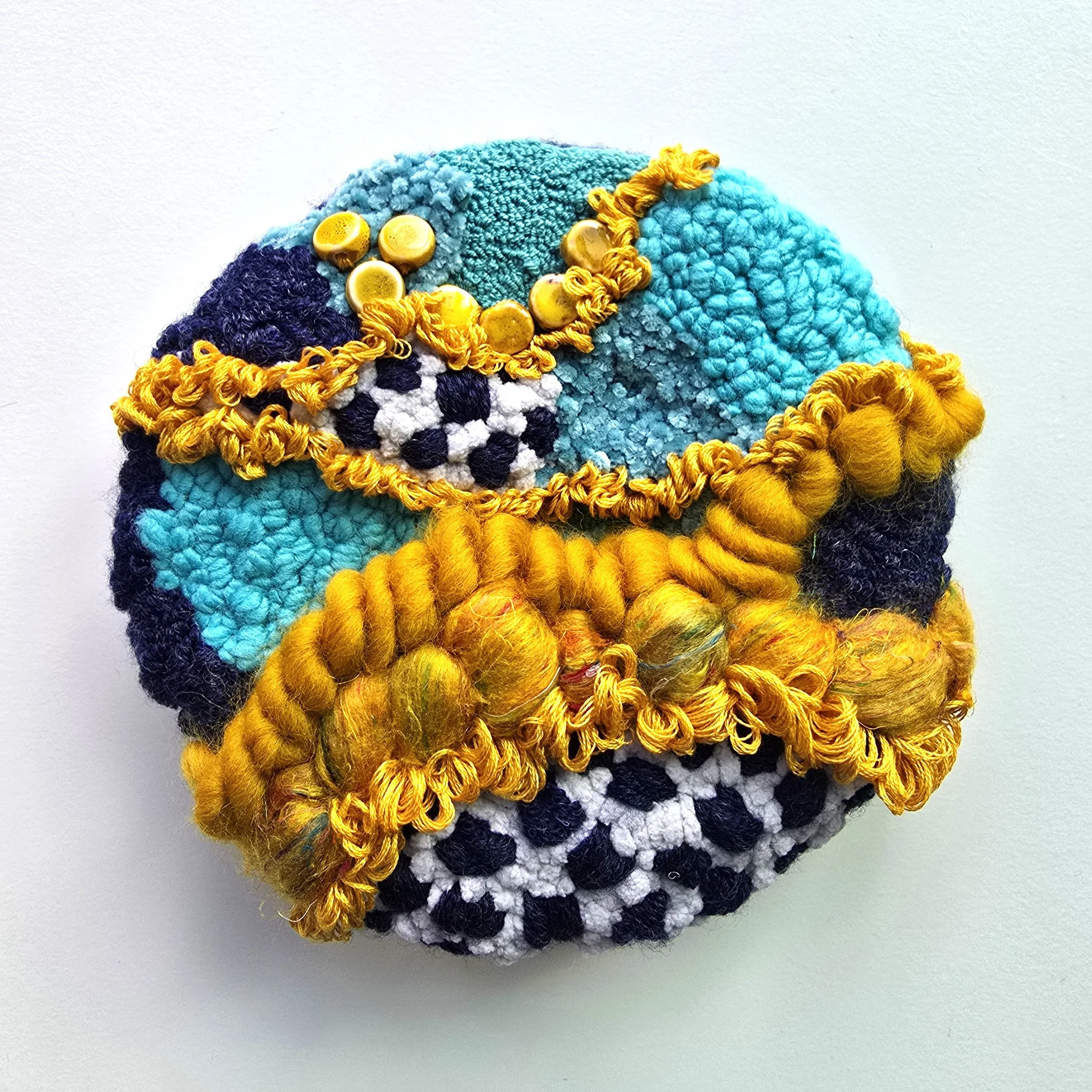 Blueberry Hill | Stitched, hooked, & punch needled mixed yarns, handspun art yarn, silk roving, cotton thread, and ceramic beading mounted on board & wired for hanging | 7" diameter x 2" deep | $150