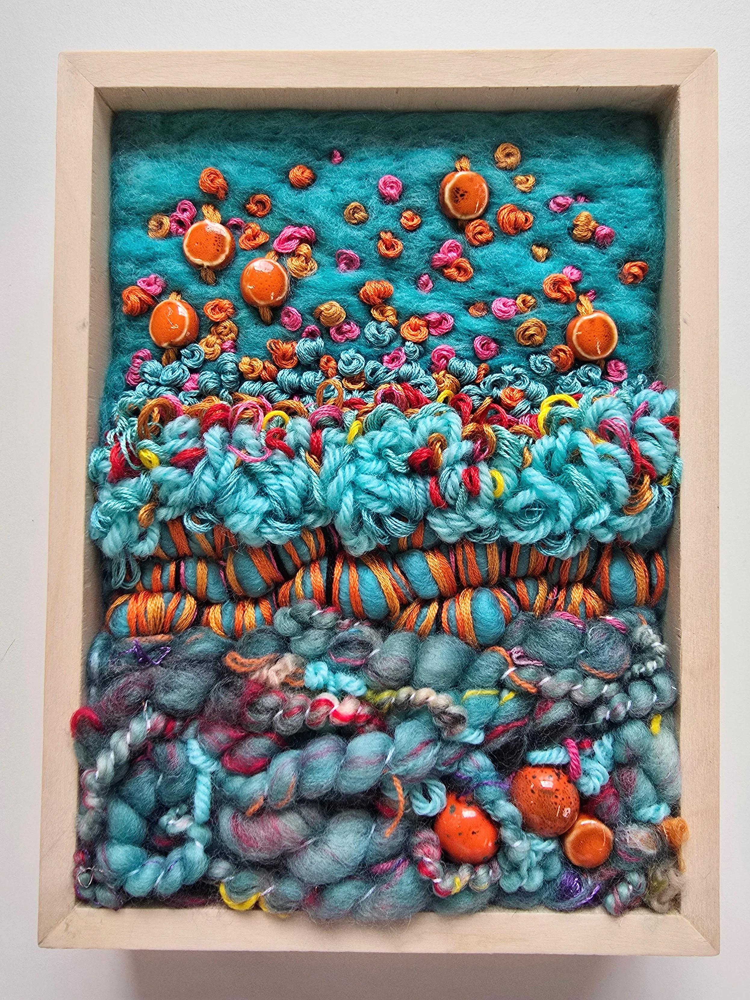 The Earth Laughs In Flowers | Needle felted wool, handspun art yarn, mixed yarns, stitching, & ceramic beads in a solid birch frame with natural finish | 6" x 8" x 2" | $150 (CDN) ***Available at Tiny Ass Art Gallery, St. Jacobs, Ontario in May 2026