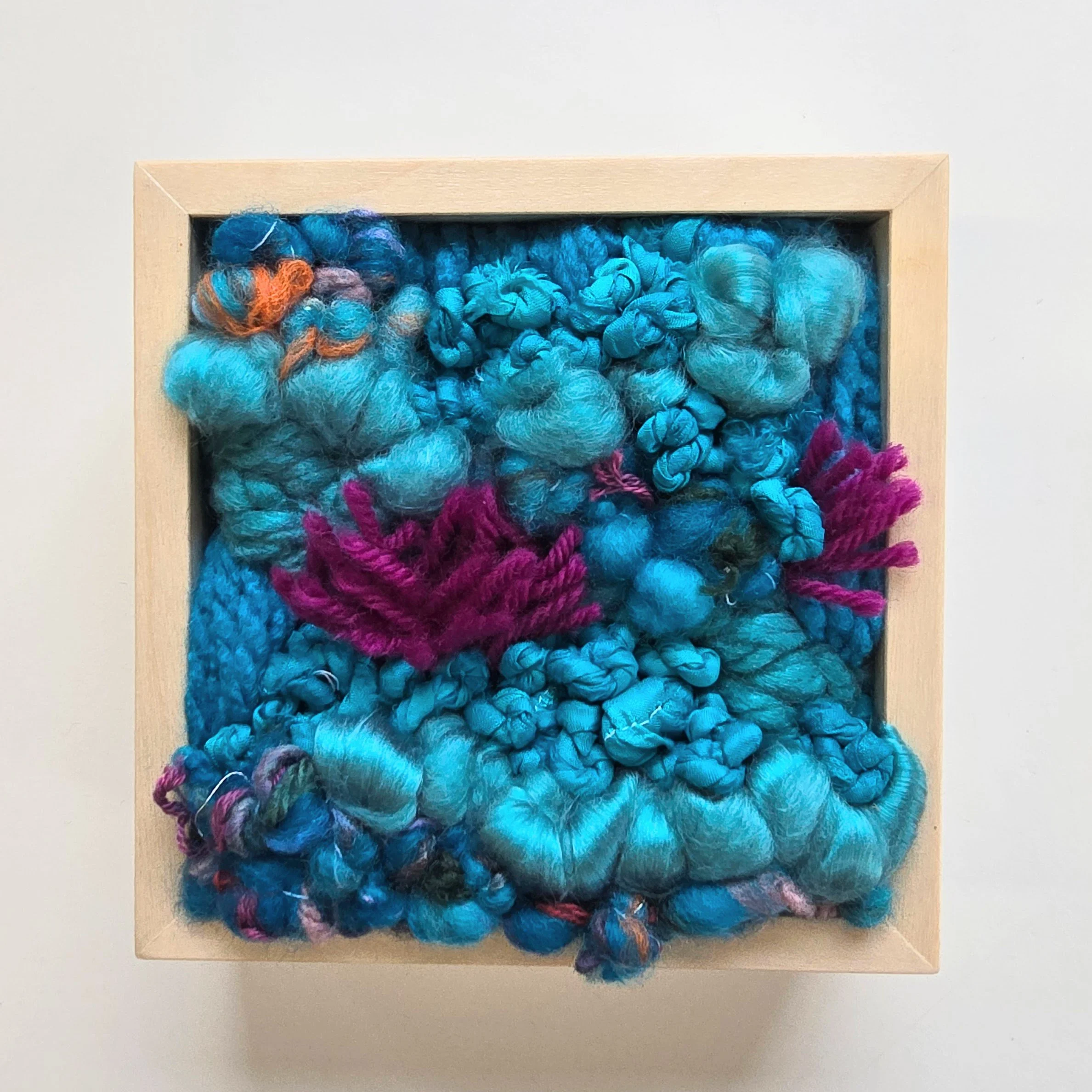 You Make My Heart Sing | Hooked wool and mixed yarns, handspun art yarn, wool roving, and recycled sari silk, in a solid birch frame with natural finish | 5” x 5” x 2” | $125
