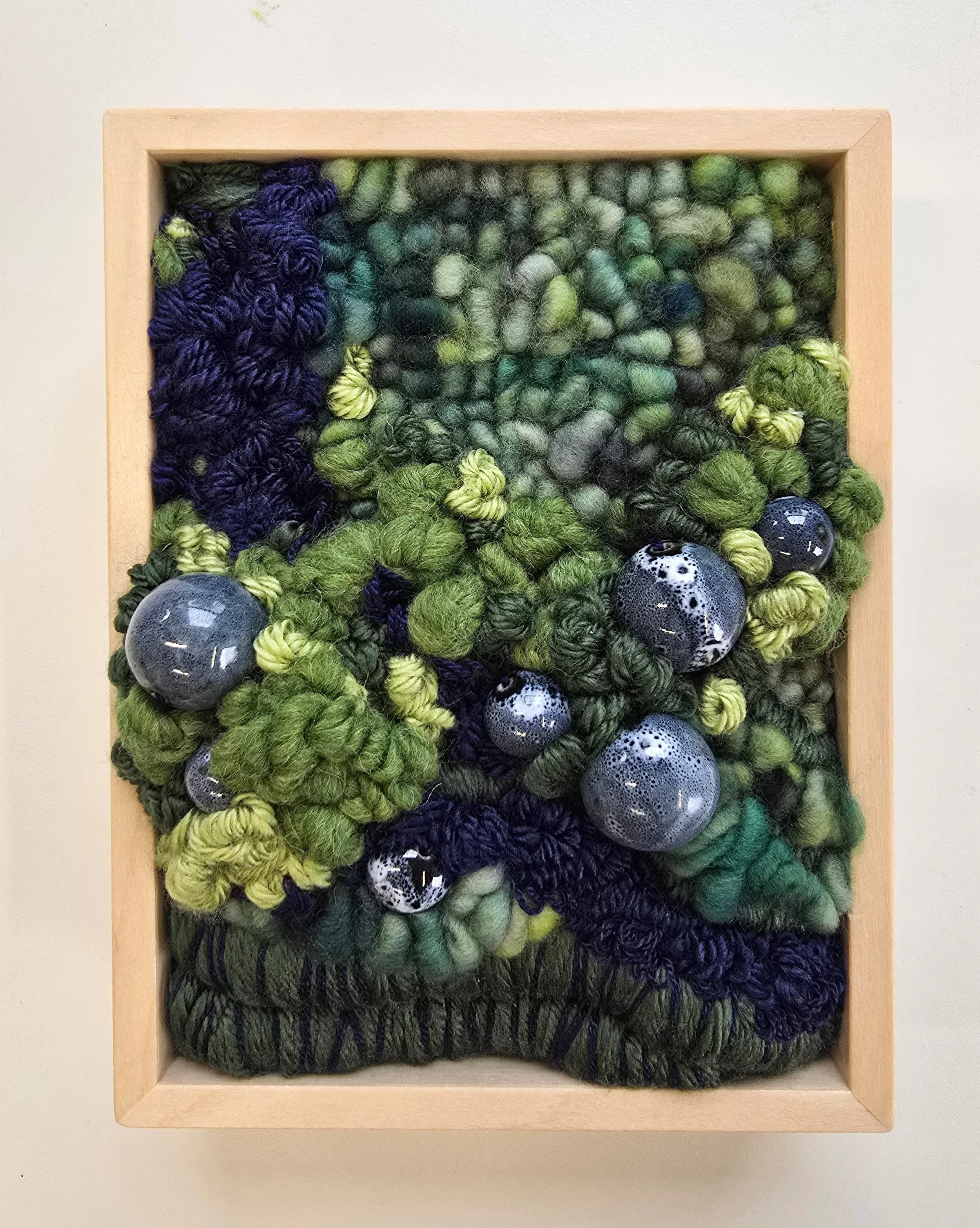 Muskoka | Hooked wool and mixed yarns, handspun art yarn, embroidery, & ceramic beading in a solid birch frame with natural finish | 6” x 8” x 2” | $175

