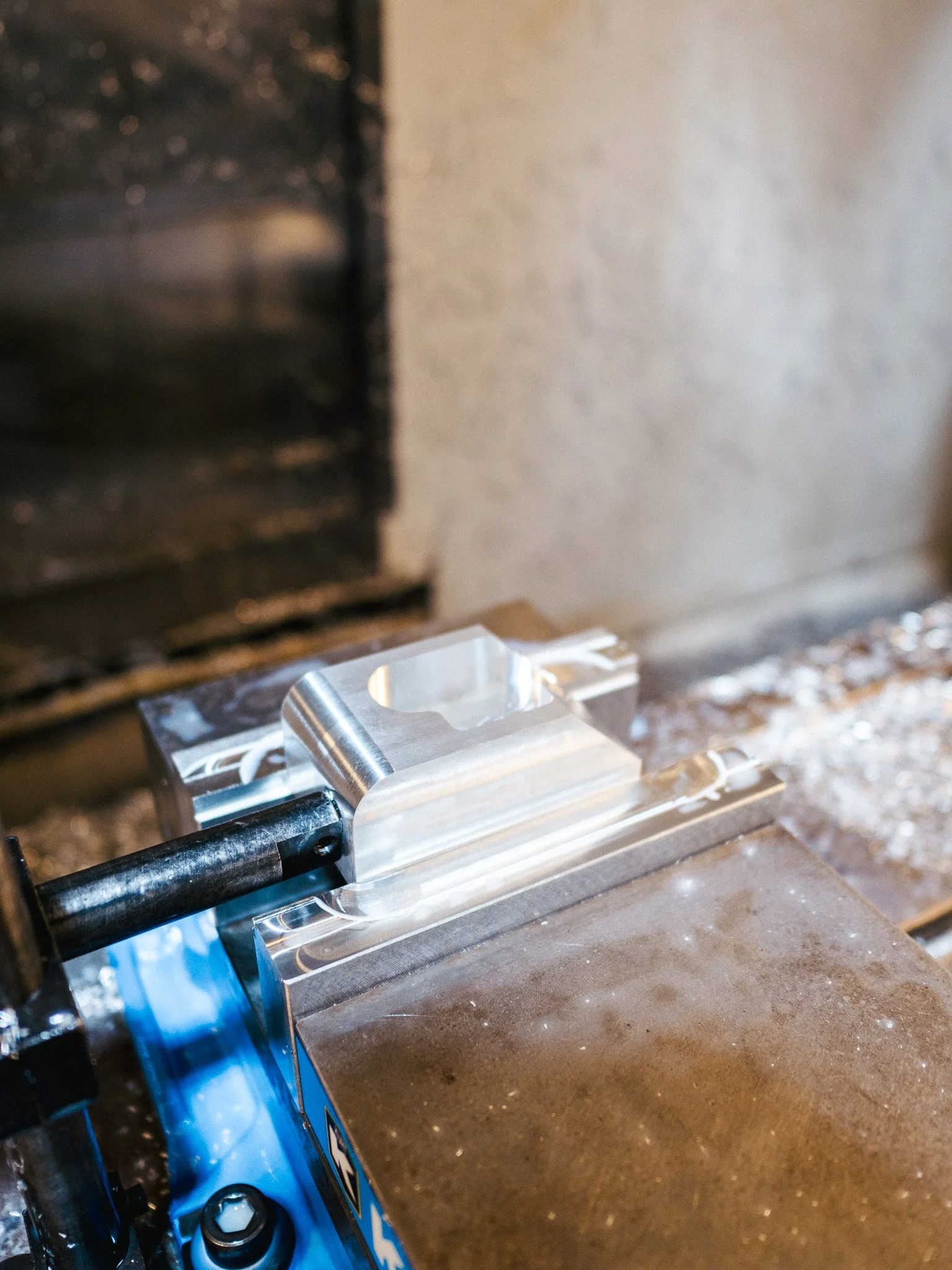 Aluminum part machined on a CNC mill with pockets and drilled holes