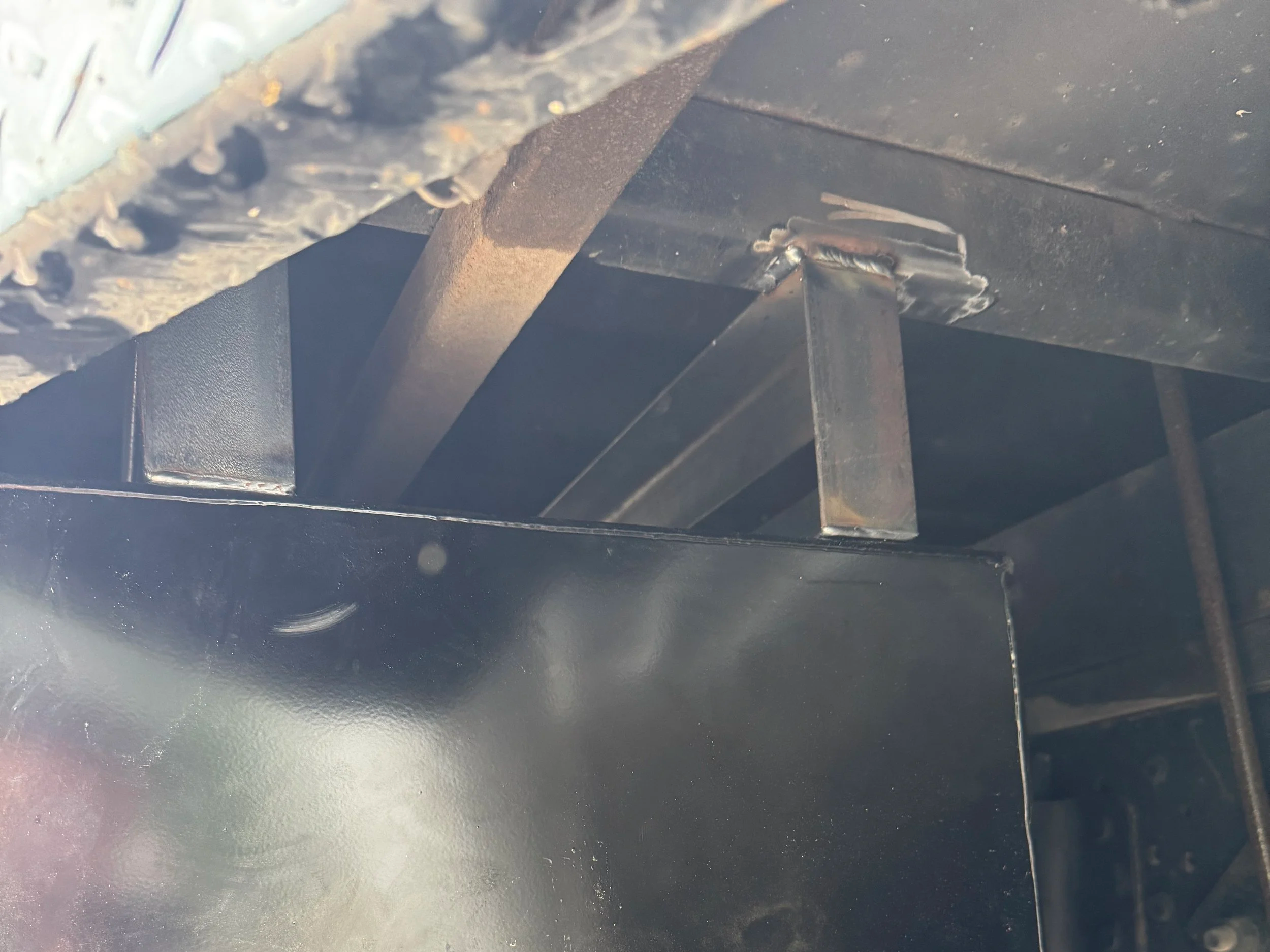 Flatbed work truck with underbody toolbox installed using custom fabrication mounts
