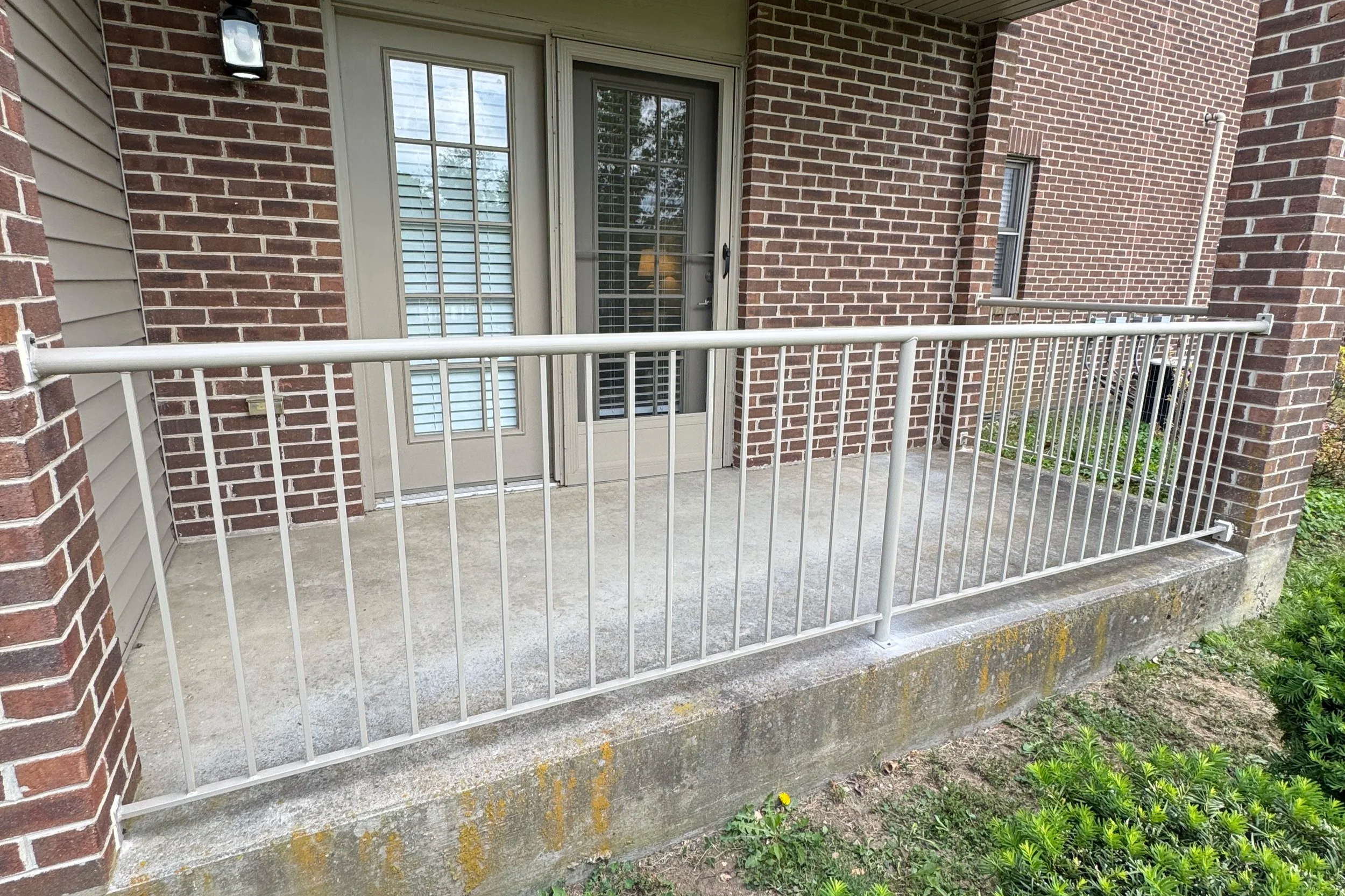 Custom steel handrail installation on residential porch in Richmond KY
