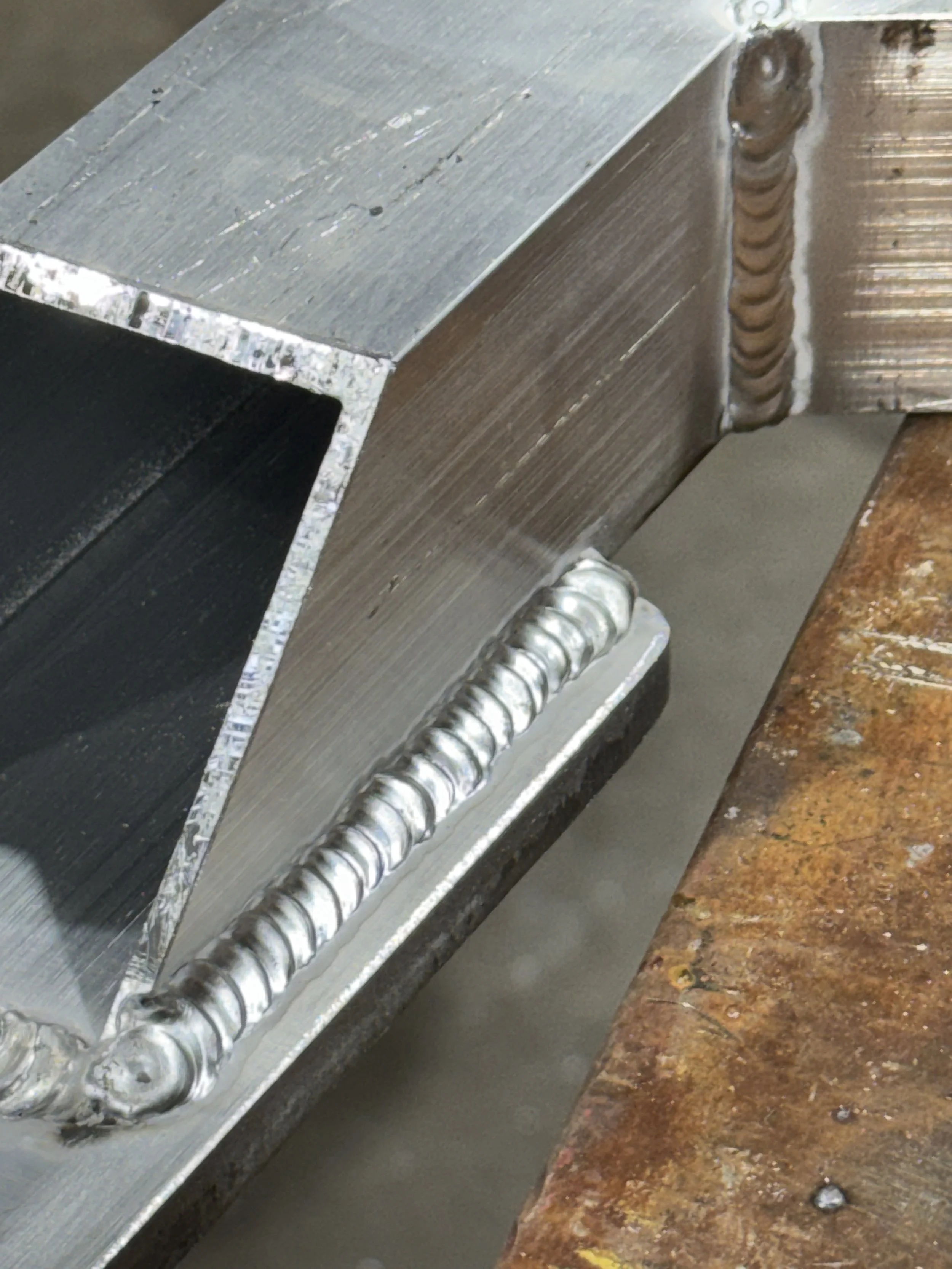 Close-up of TIG welded aluminum handrail connection showing clean weld quality.
