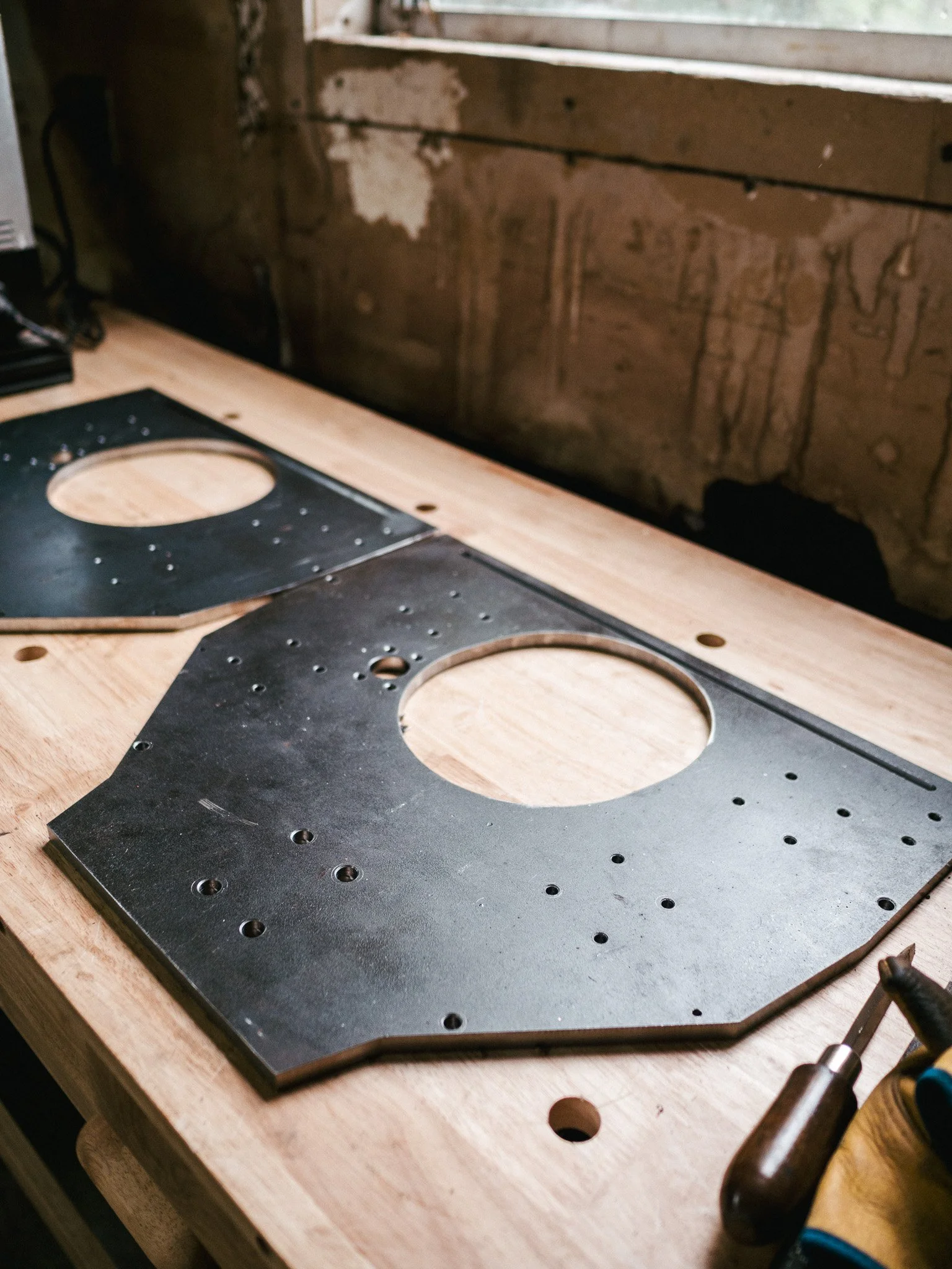 Precision-machined steel plate used in industrial machinery and automation assemblies, featuring drilled and milled features.