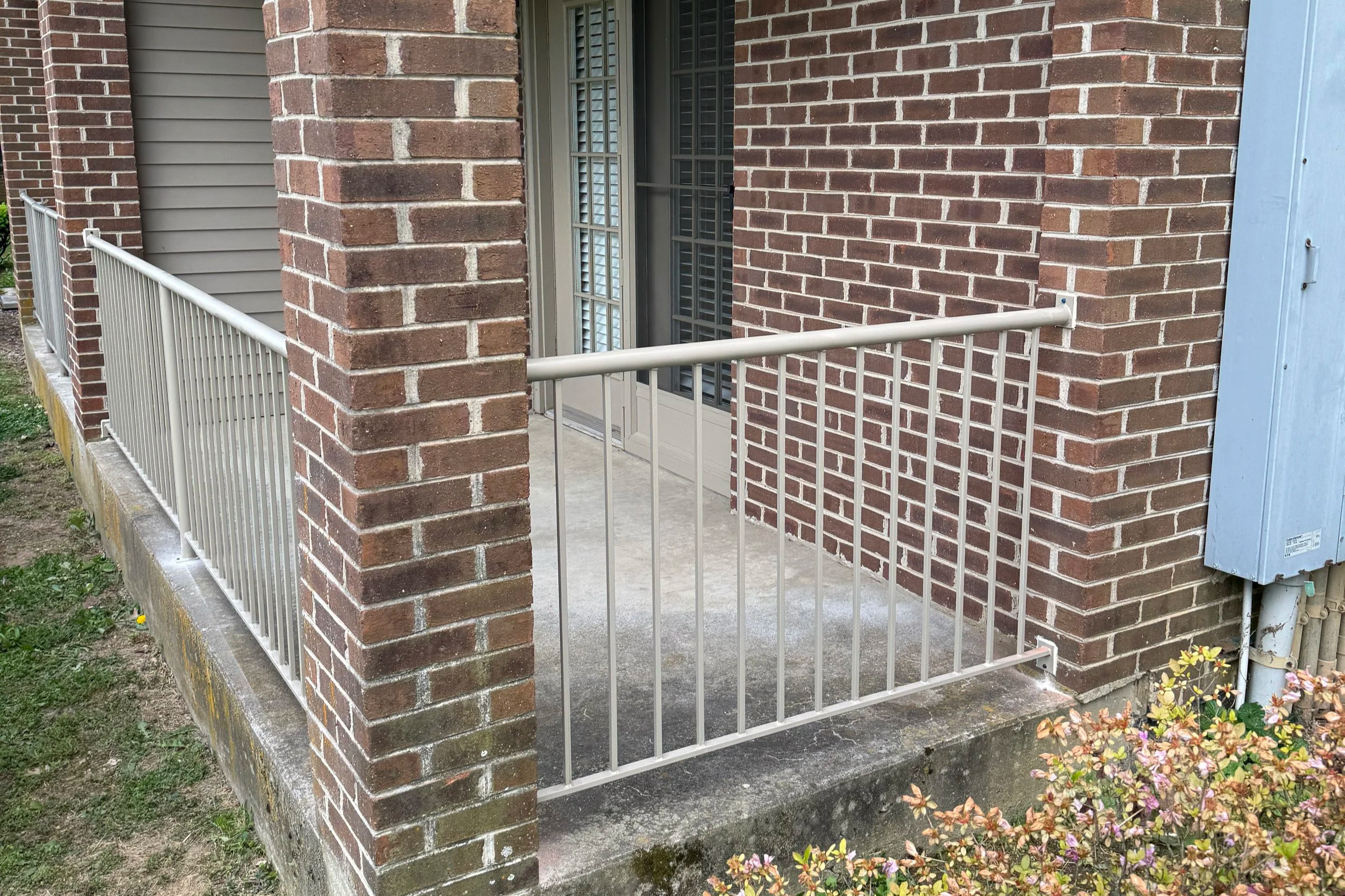 Custom steel railing system installed on concrete porch serving Richmond and Berea Kentucky