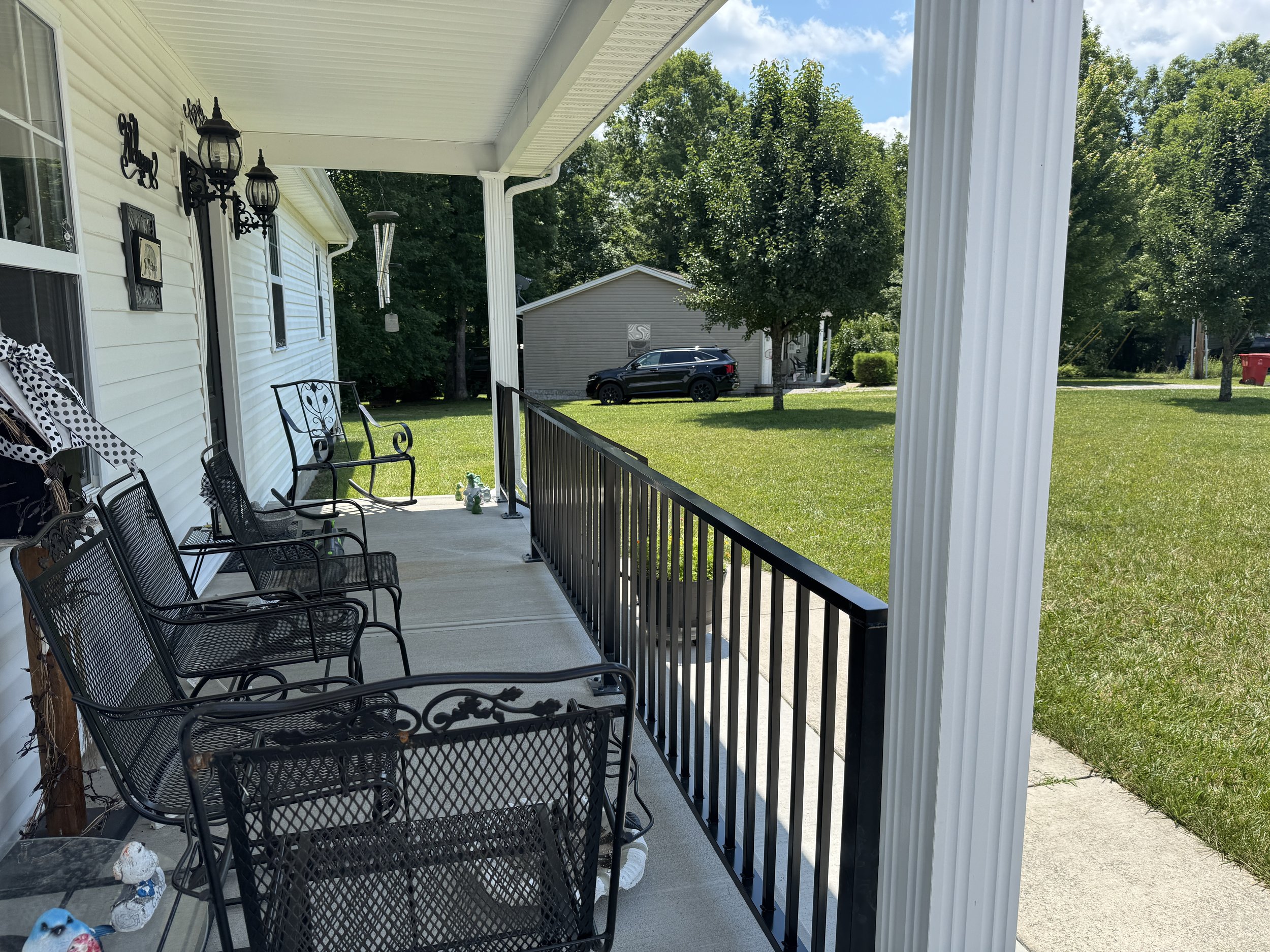 Black aluminum porch railing custom fabricated and installed for a home in Corbin, KY, featuring welded construction and a durable powder-coated finish.
