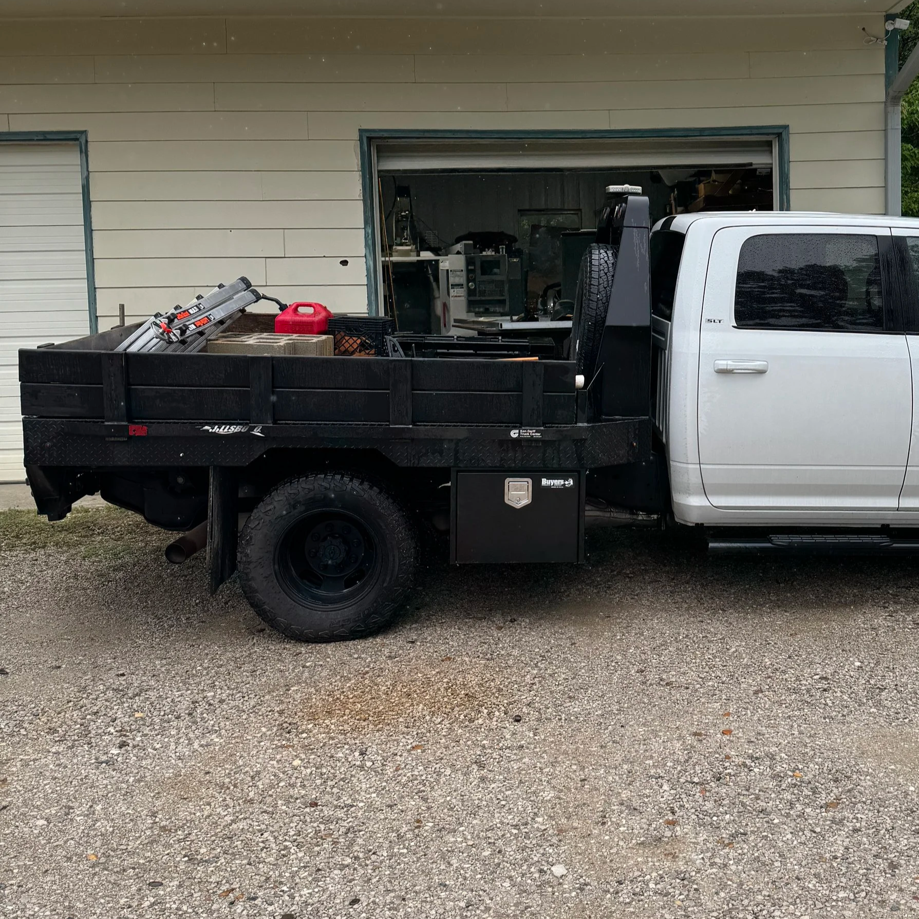 Custom underbody toolbox mounted under flatbed truck with welded steel brackets in Corbin Kentucky
