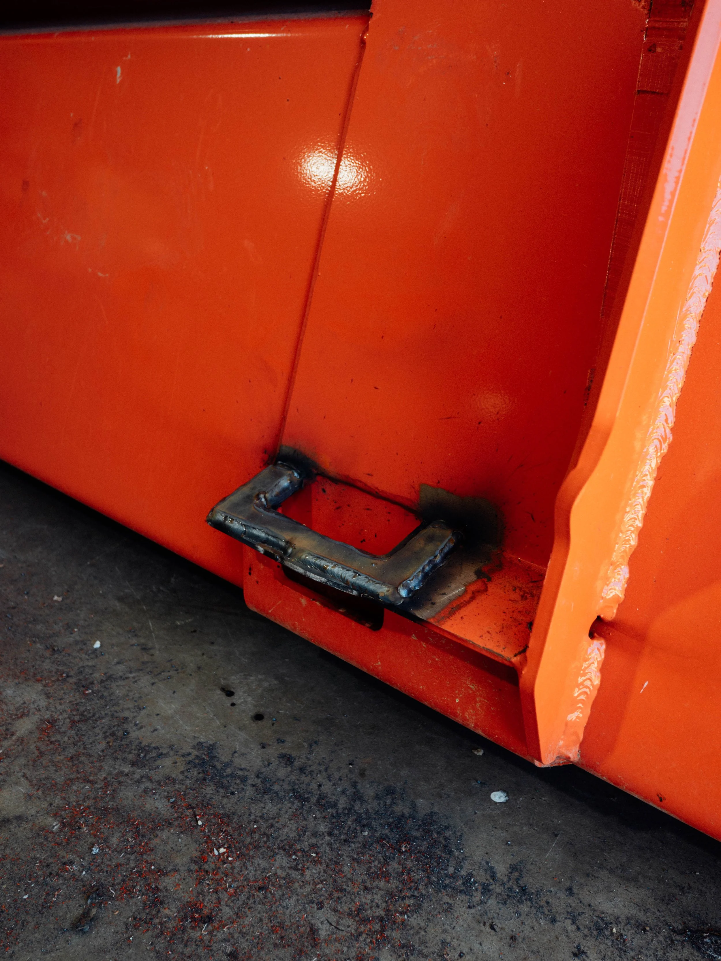 Welded tractor bucket repair with reinforced steel and rebuilt mounting area in London Kentucky