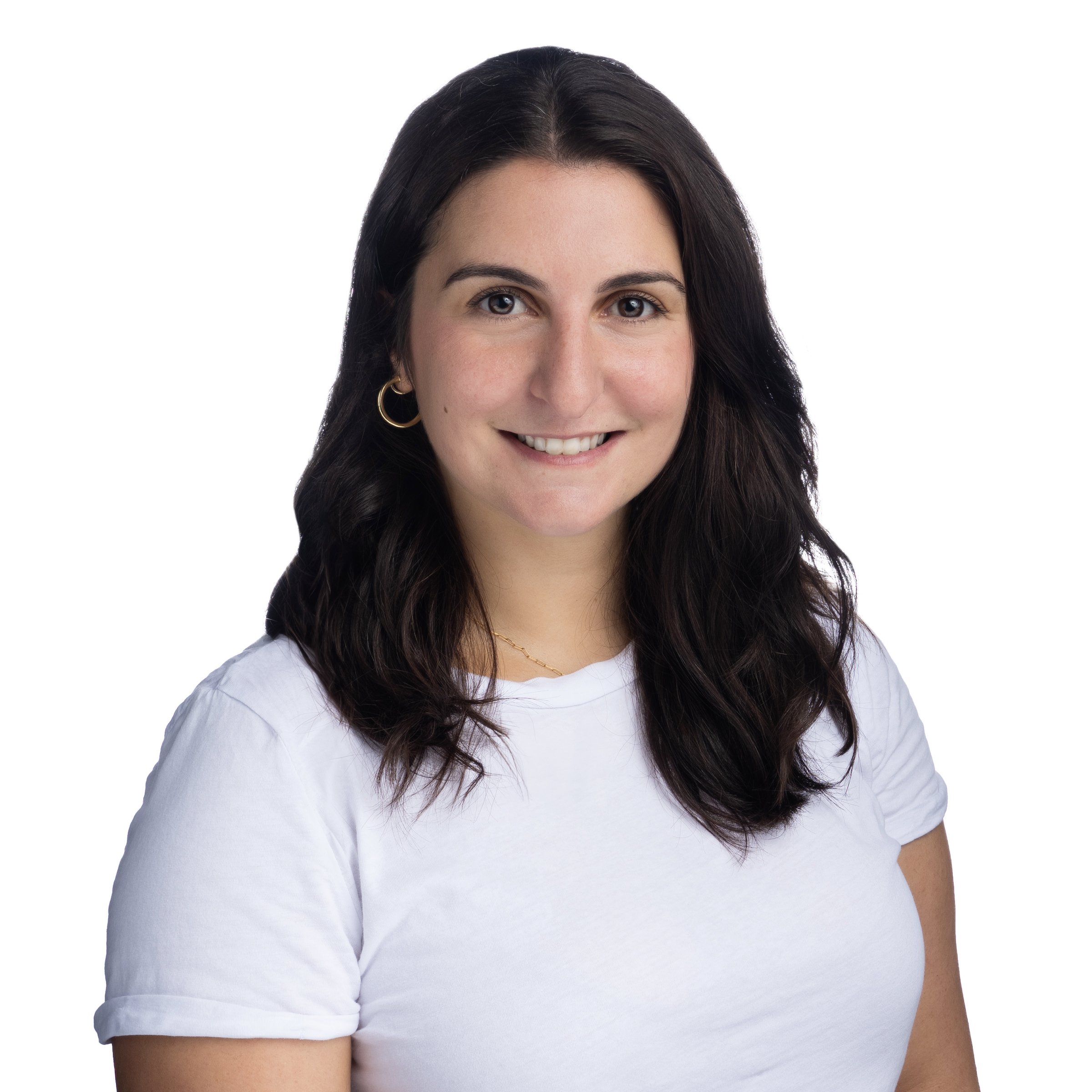 Portrait of a woman with long dark hair wearing a white t-shirt, smiling, against a white background.