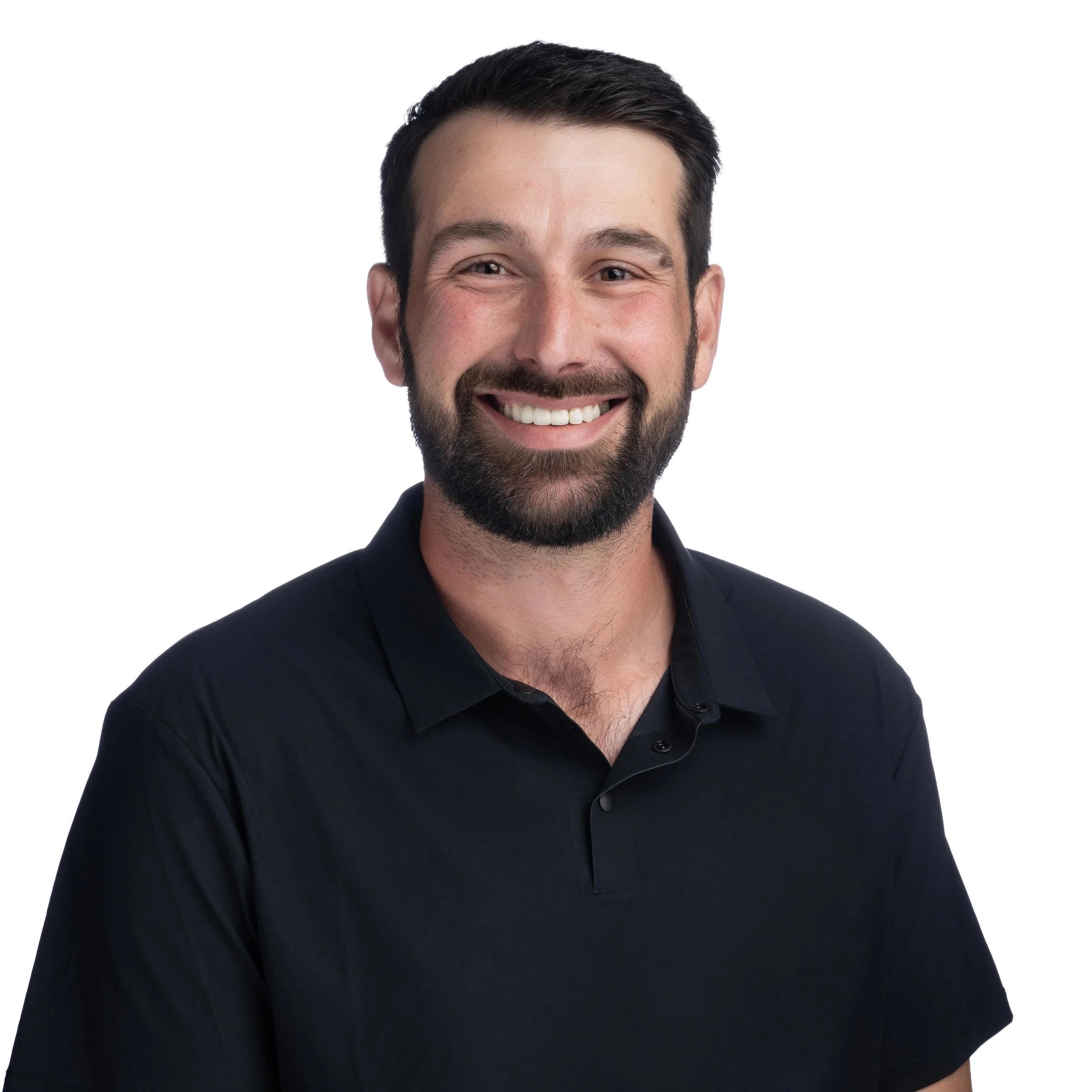 Smiling man with a beard wearing a black shirt against a white background.
