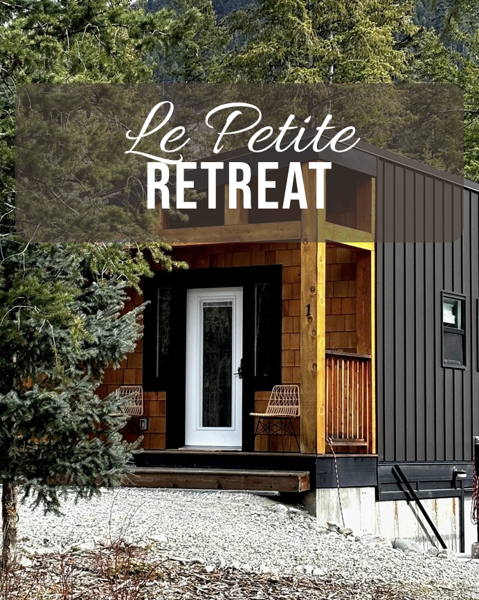 Le Petite Retreat, a black and cedar tiny home in the forest with a covered front porch