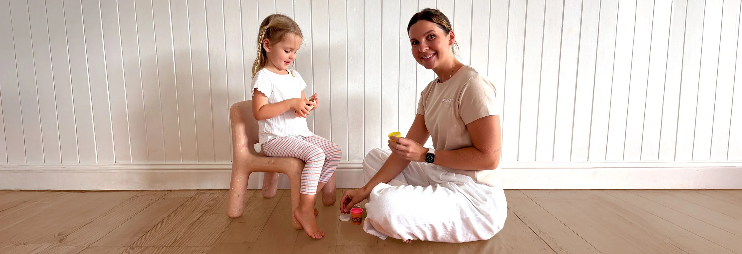 Paediatric occupational therapist from Kinleap supporting a young girl during a Play-Doh therapy activity on the Sunshine Coast.