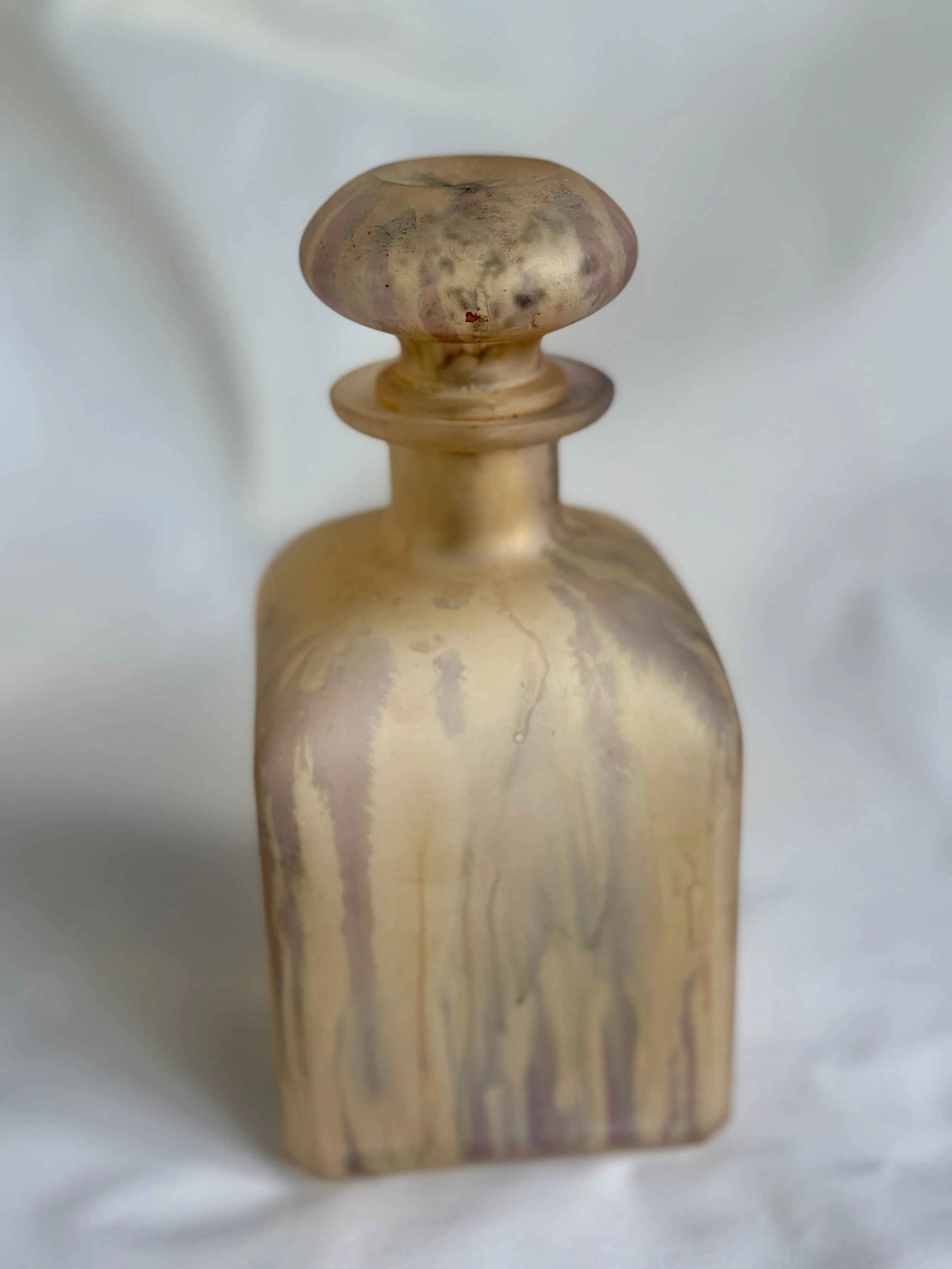 Close-up of a wooden finial with a round top and a narrow base, displaying wood grain and some discoloration. Available in the Curated by Curtis online Vintage Store. 