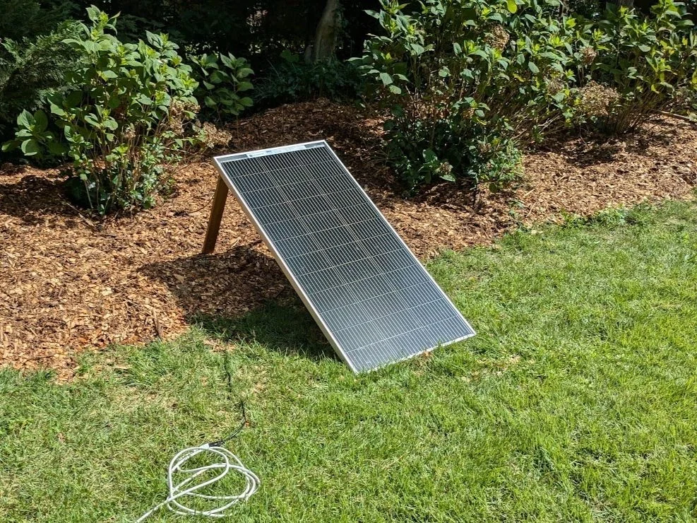 Seed solar product next to bushes.