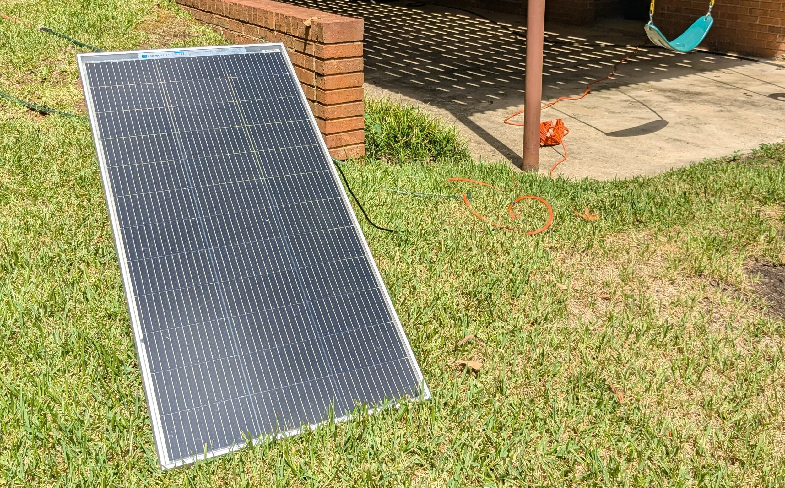 Seed solar product in a lawn next to a house.