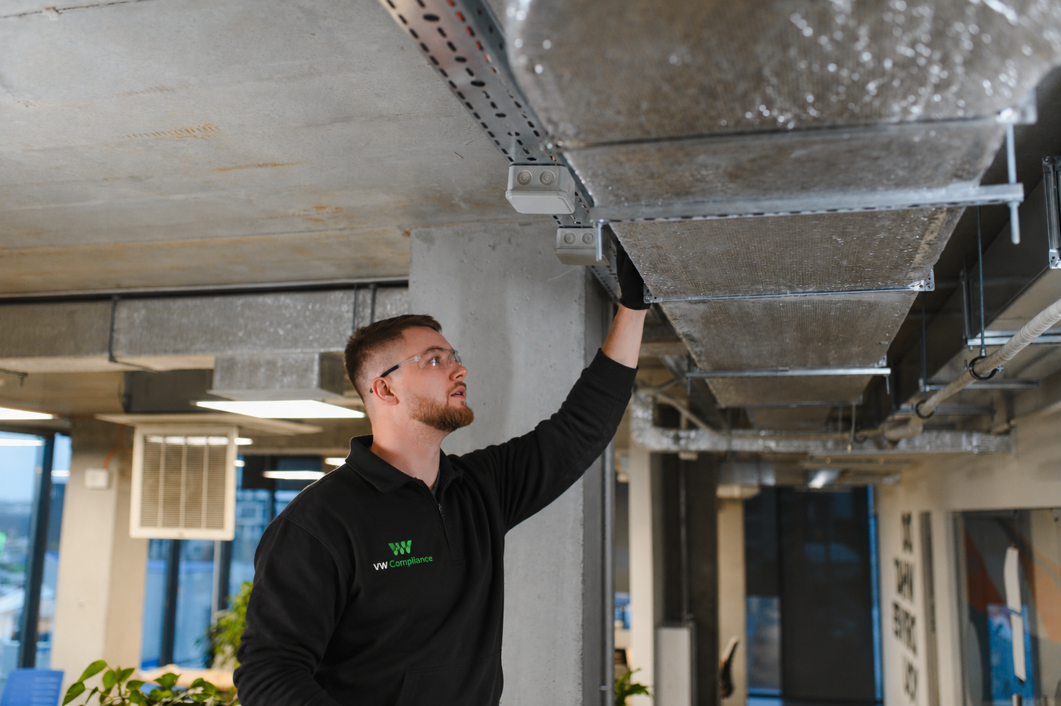 Engineer inspecting commercial HVAC system in office building