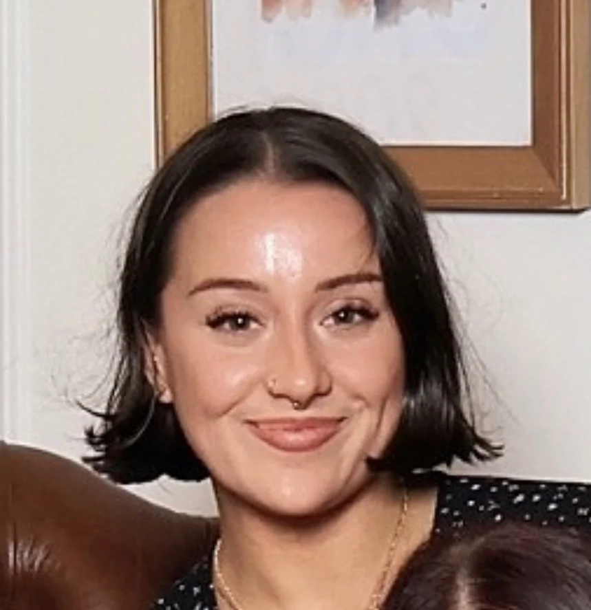 a woman with short brown hair smiling