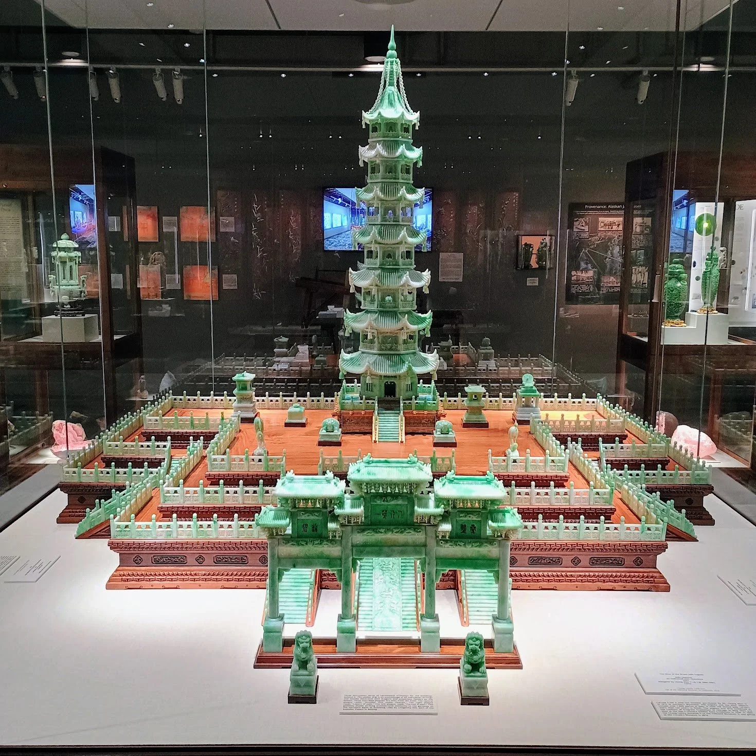 Image shows a giant wood and carved jade palace or pagoda with a tall tower.